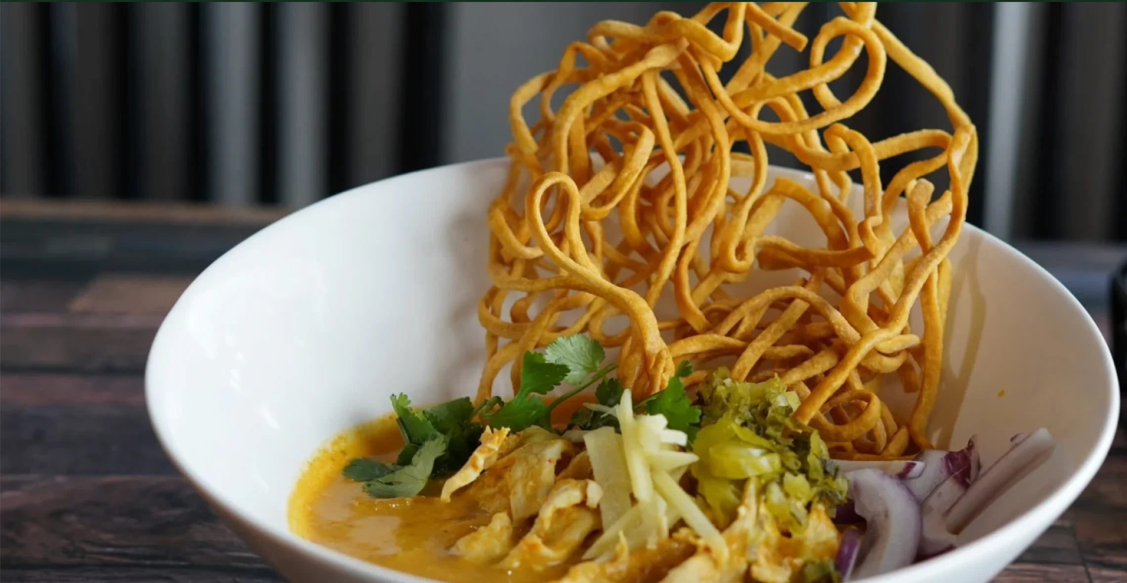 Bowl of Burmese Khao Soi with crispy noodles