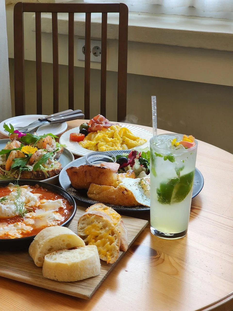 Colorful brunch spread featuring shakshuka and refreshing mojito