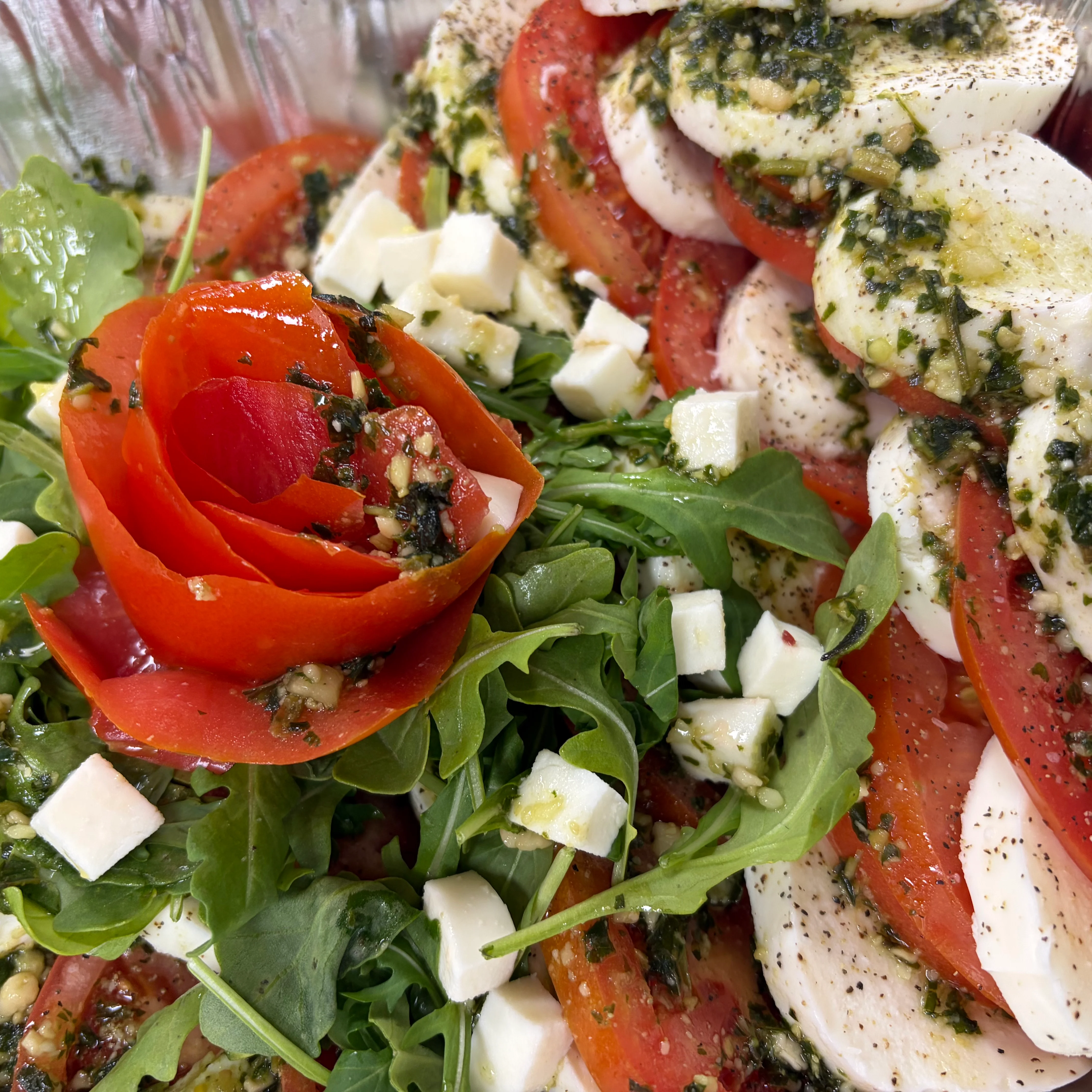 Italian caprese salad with tomatoes, mozzarella, basil, and arugula