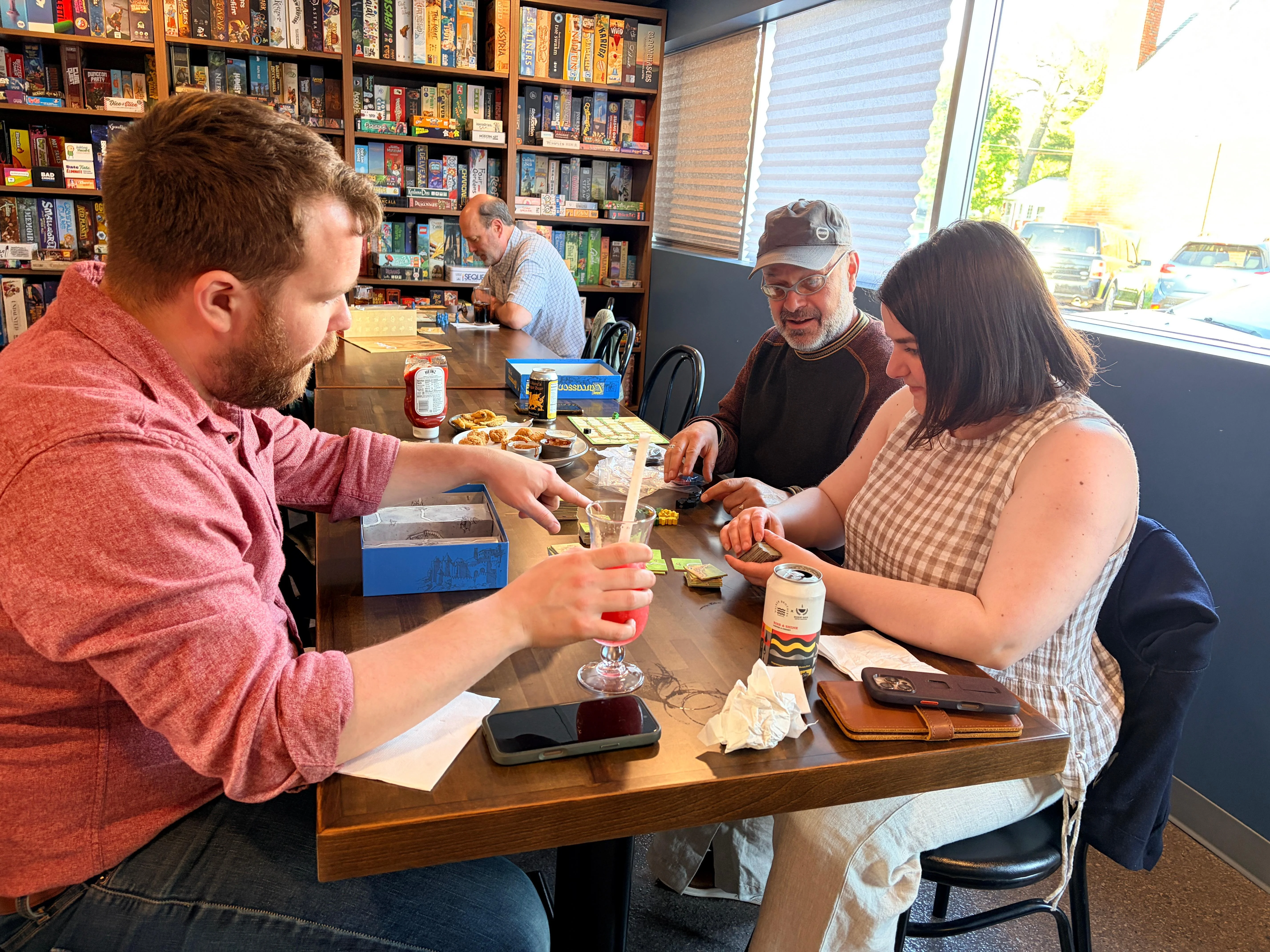 Group enjoying board games in a cozy cafe setting