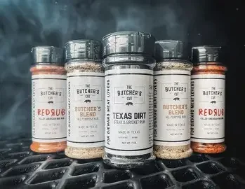 A variety of gourmet rubs and seasonings displayed in jars.