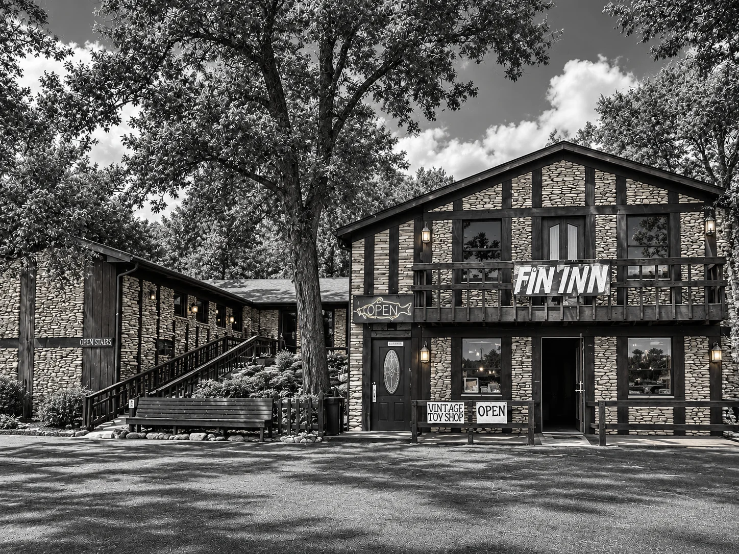 A rustic building facade of a restaurant with large windows, stone walls, and signs indicating it is open for business.