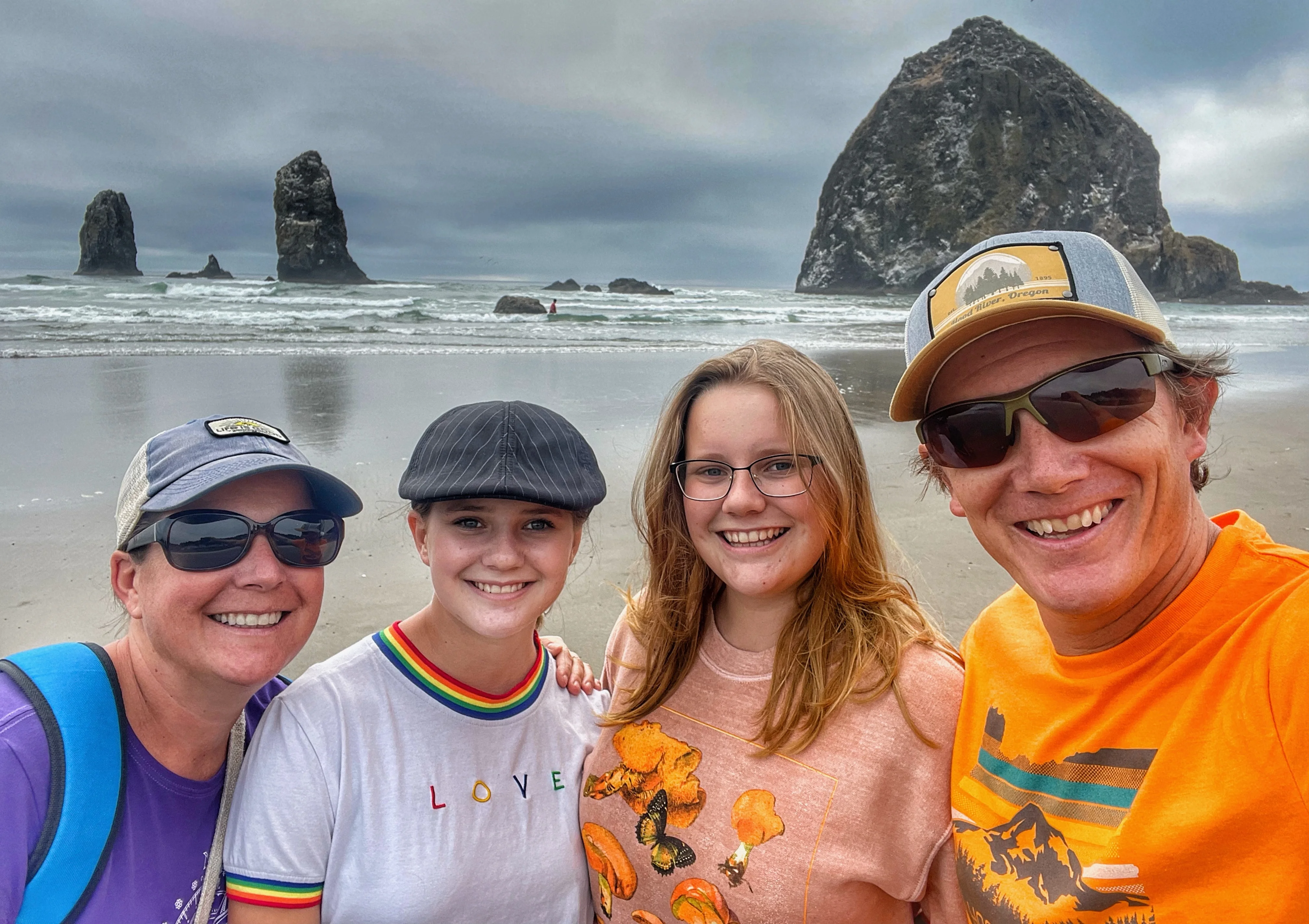 Family portrait at Cannon Beach with iconic rock formations