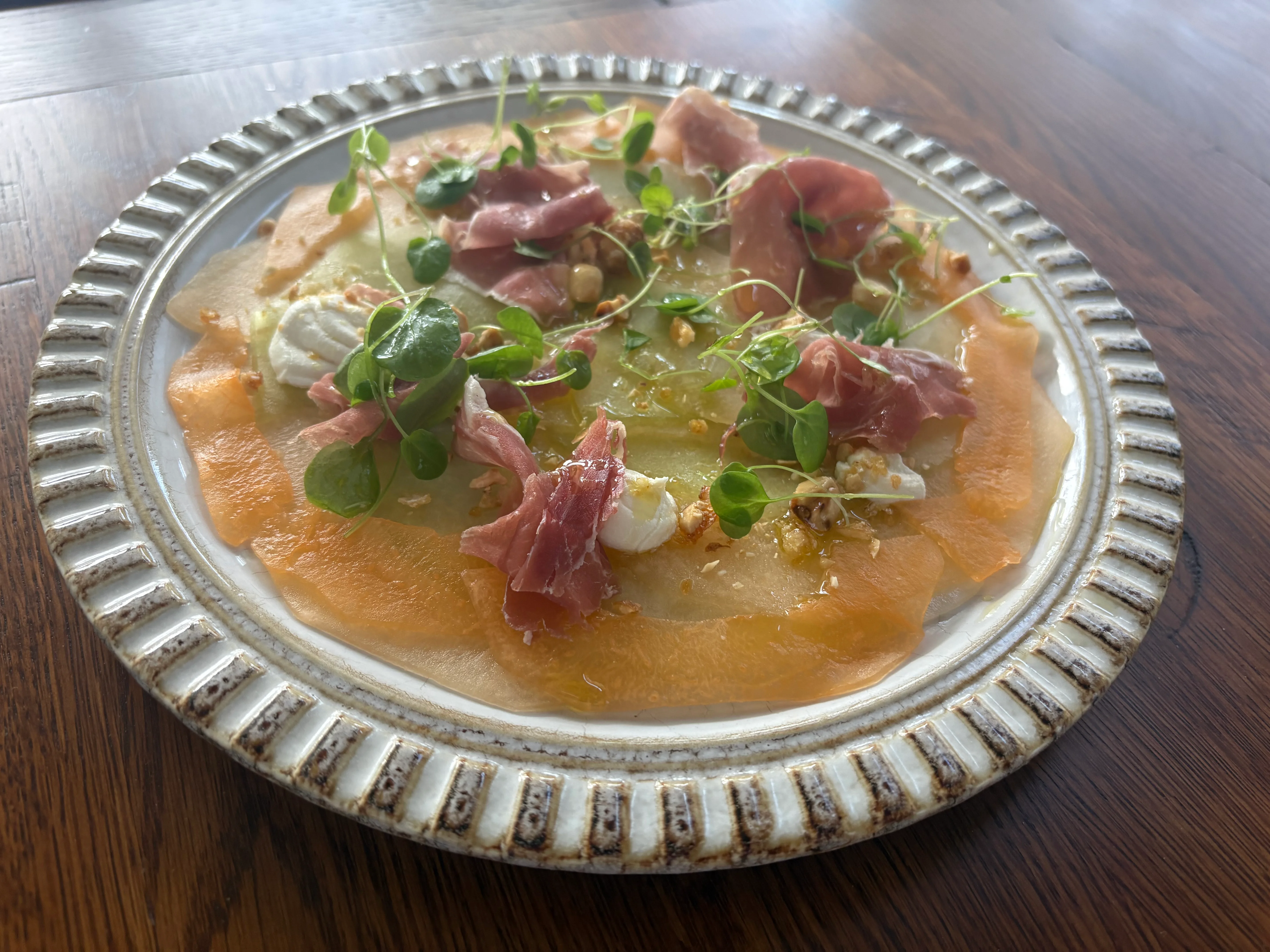 Italian carpaccio with prosciutto and microgreens on a decorative plate
