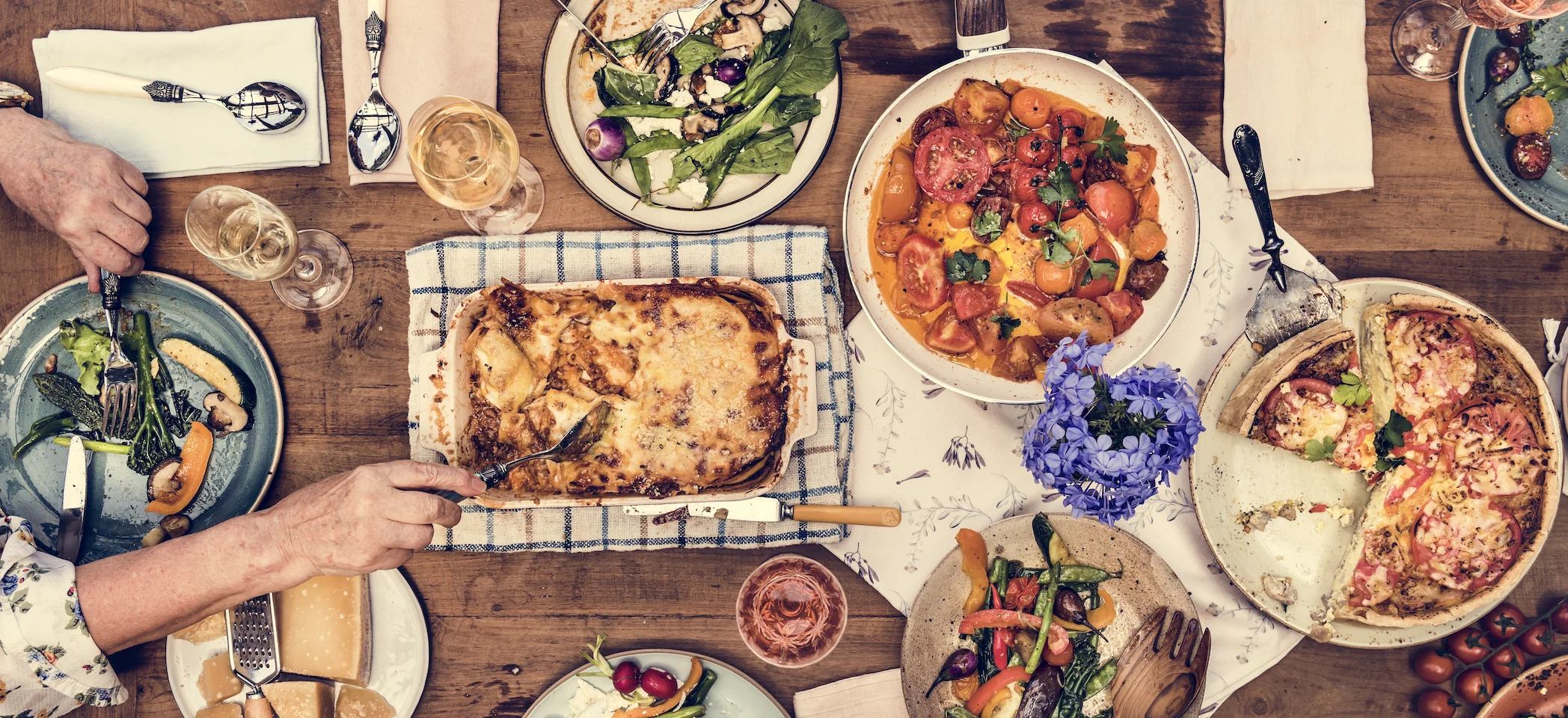 Italian lasagna served with fresh salads and wine