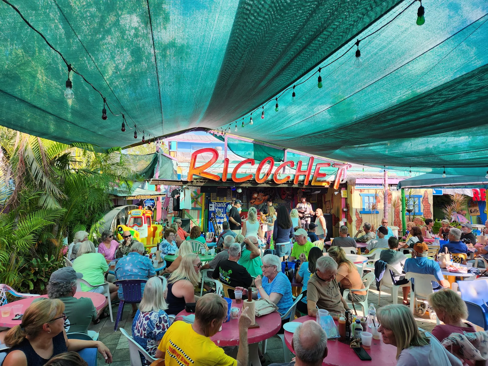 Vibrant outdoor dining area at Ricochet restaurant with colorful decor