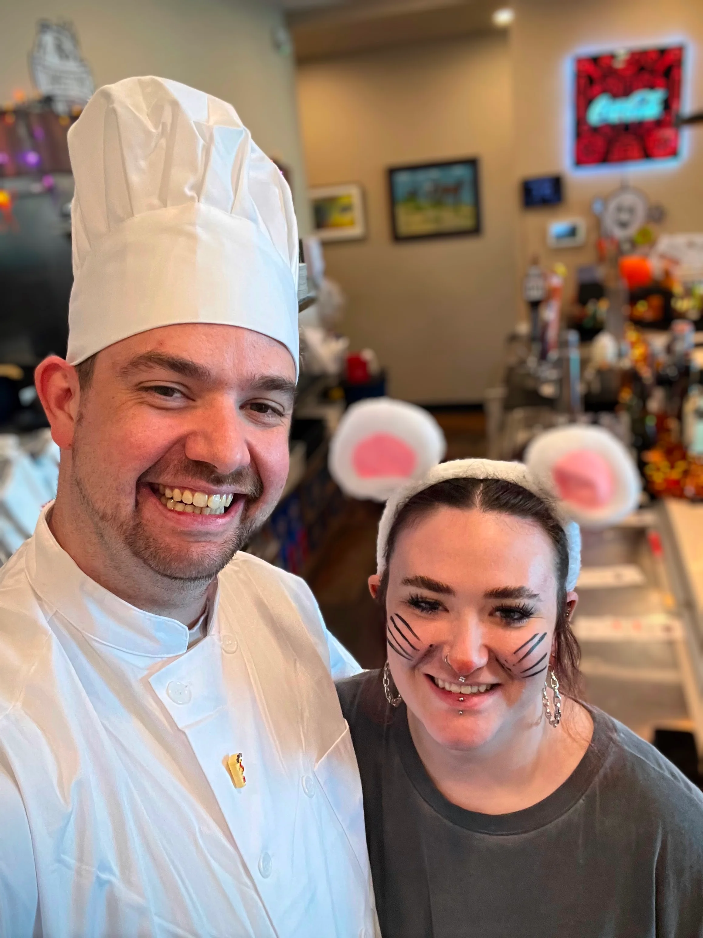 Chefs posing in a restaurant with festive attire