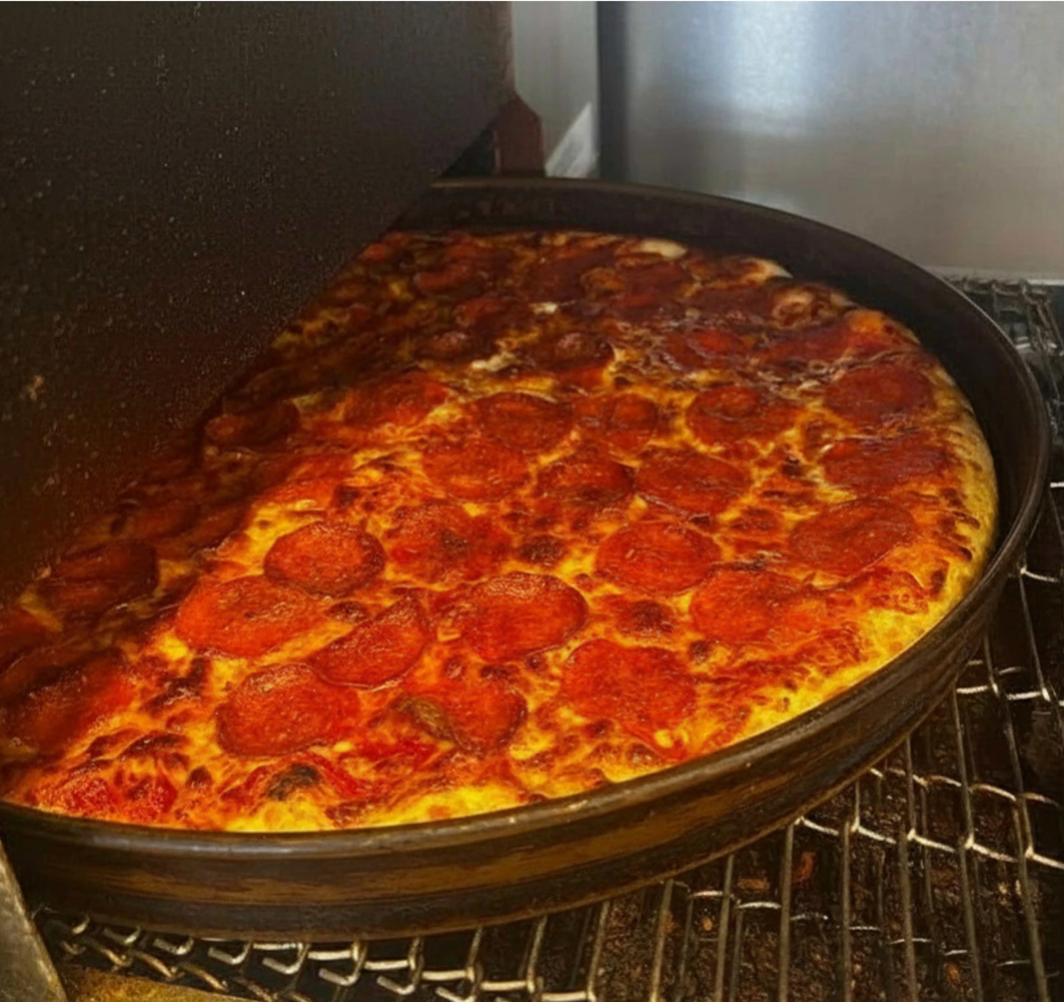 Freshly baked pepperoni pizza from a commercial oven