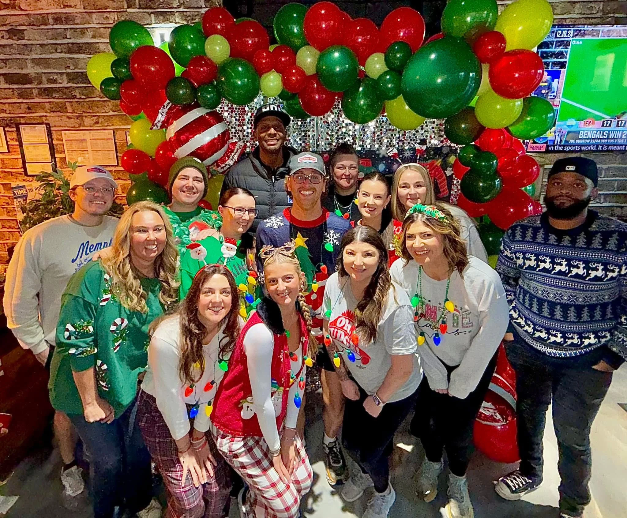 Festive restaurant staff celebrating Christmas with decorations and holiday attire