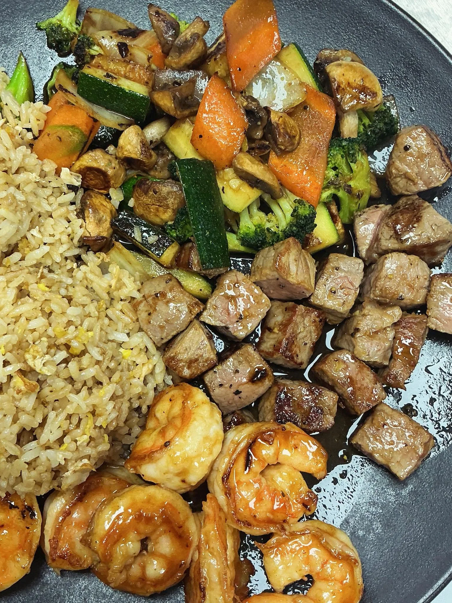 Delicious chicken teriyaki with fried rice and sautéed vegetables