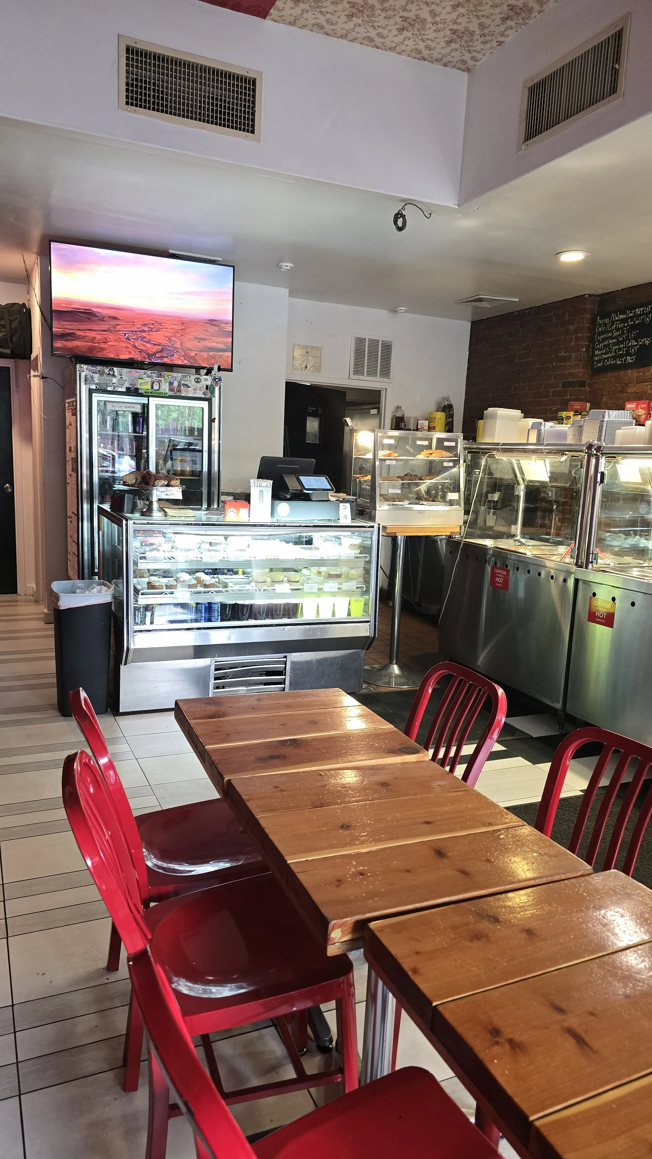 Cozy restaurant interior with red chairs and display cases