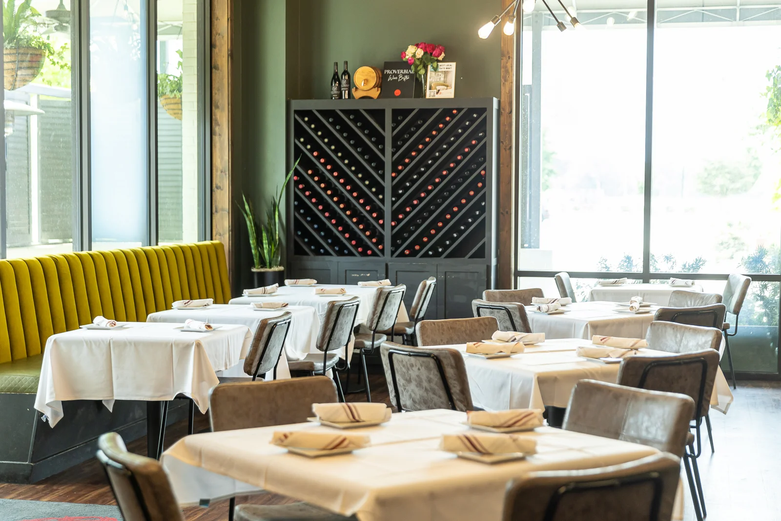 Elegant restaurant interior with wine display and cozy seating