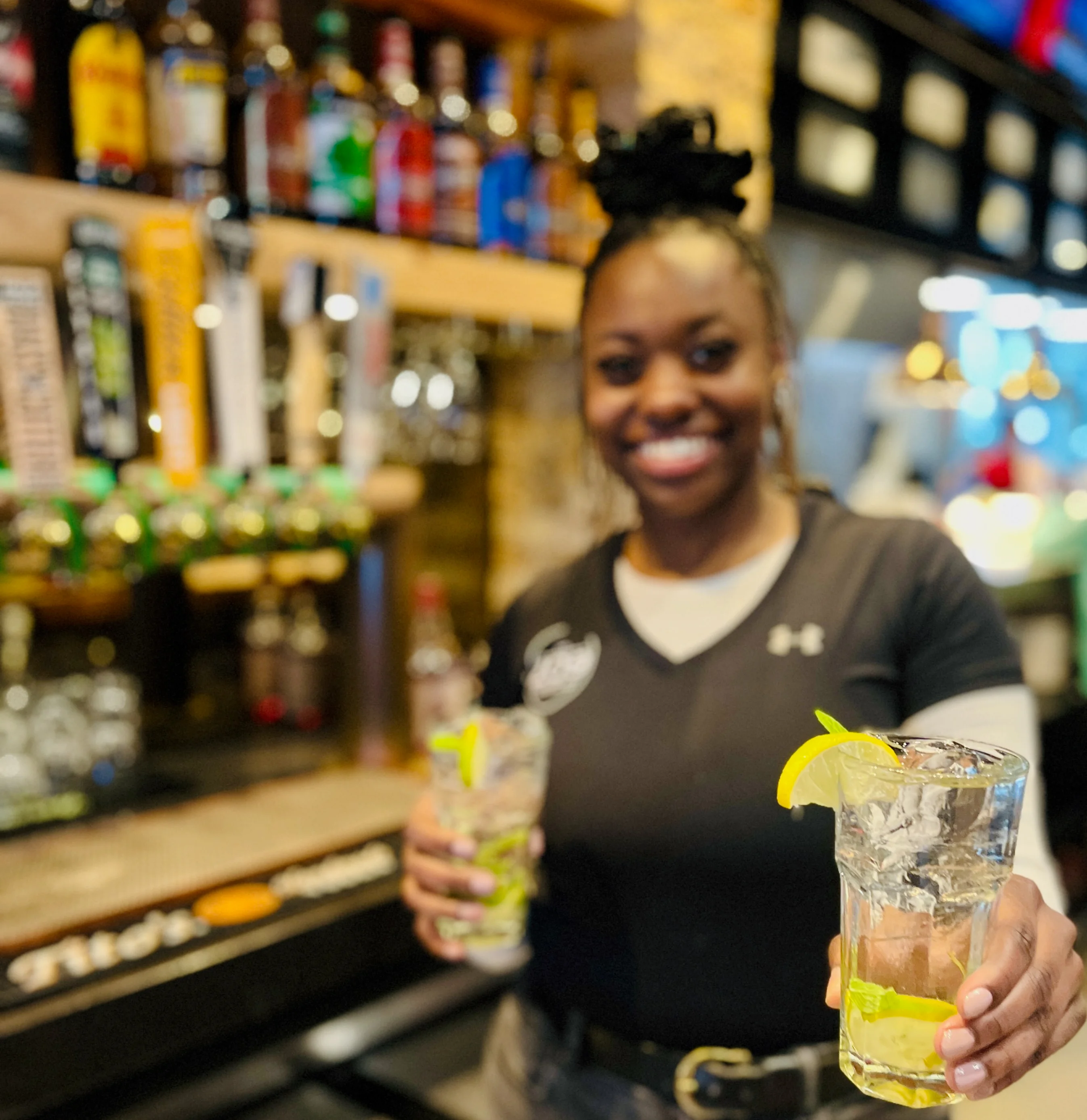 Bartender serving refreshing cocktails at a lively bar