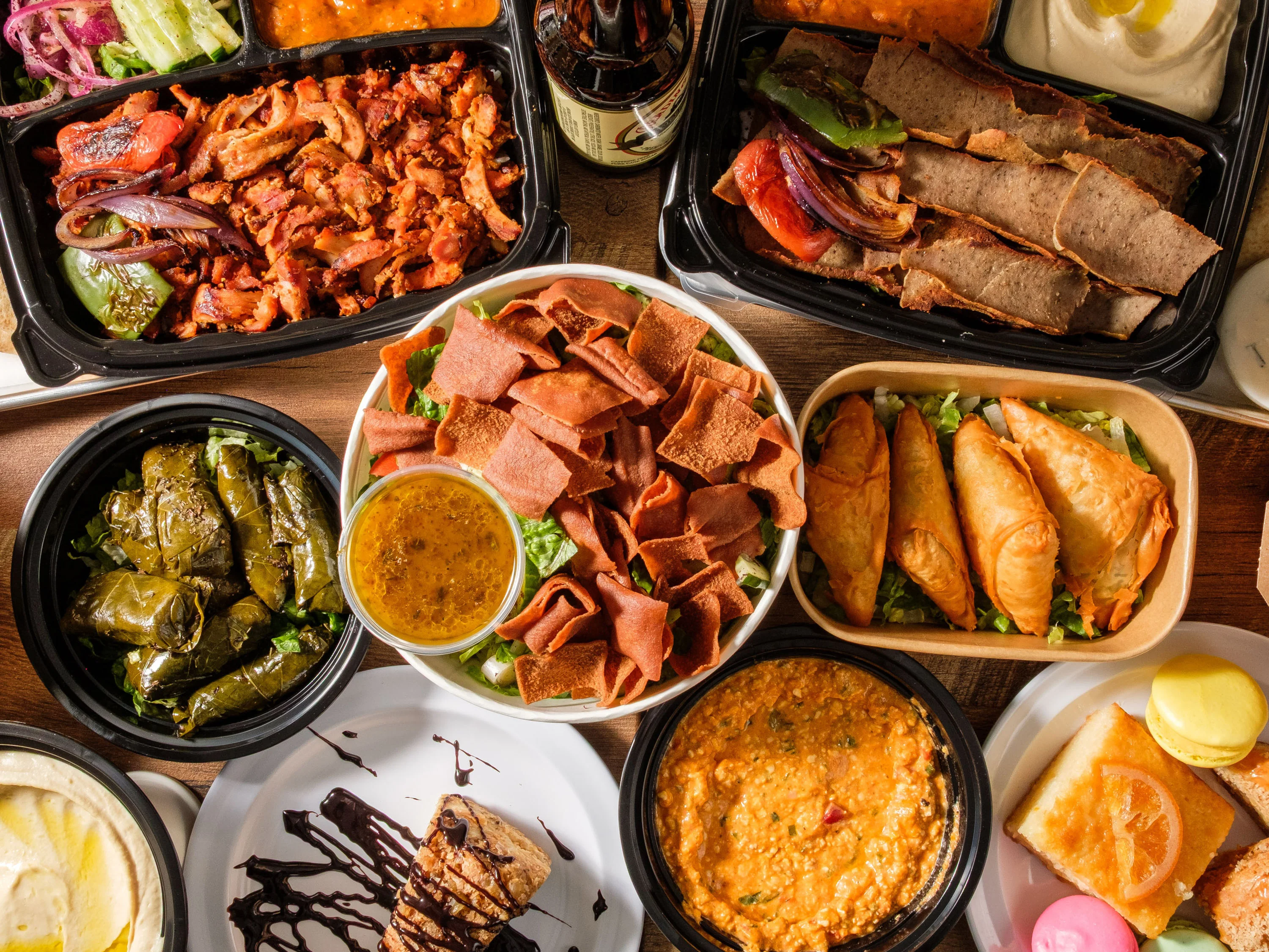 Assorted Middle Eastern dishes including kebabs and dolmas