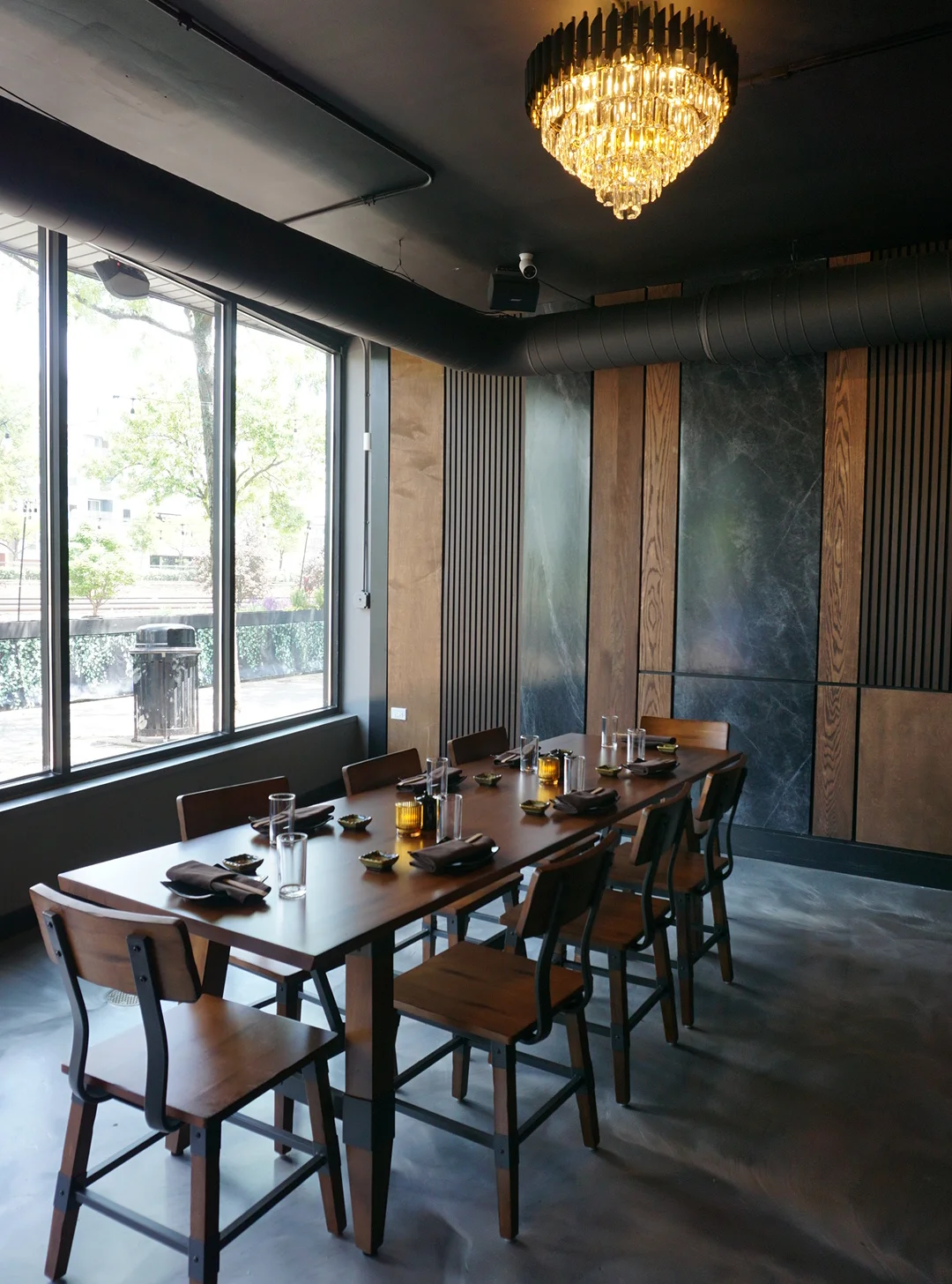Elegant dining area with a long wooden table and stylish decor.