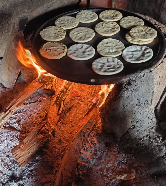 Traditional tortillas cooking on a wood-fired stove