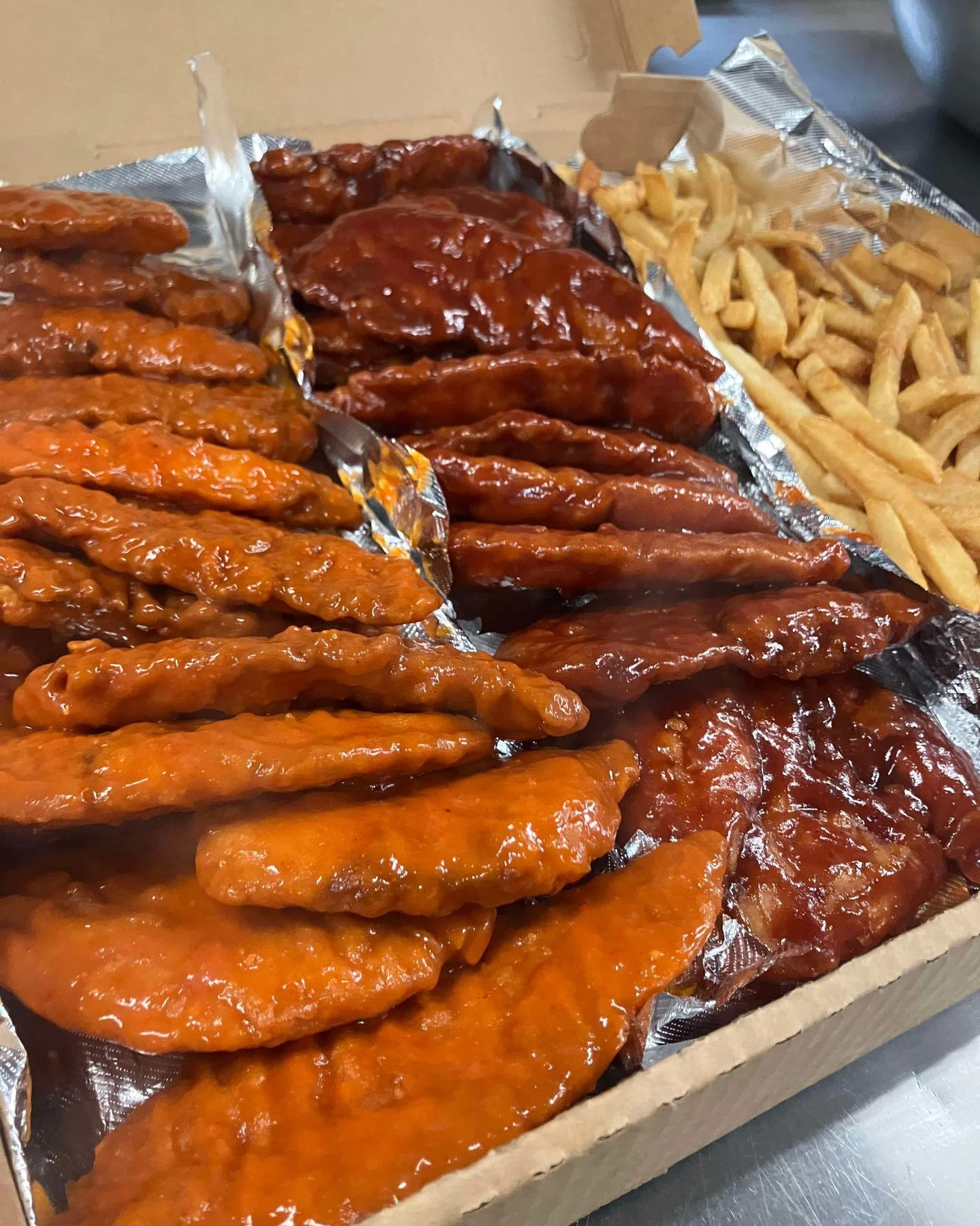Crispy chicken tenders with sweet sauce and fries