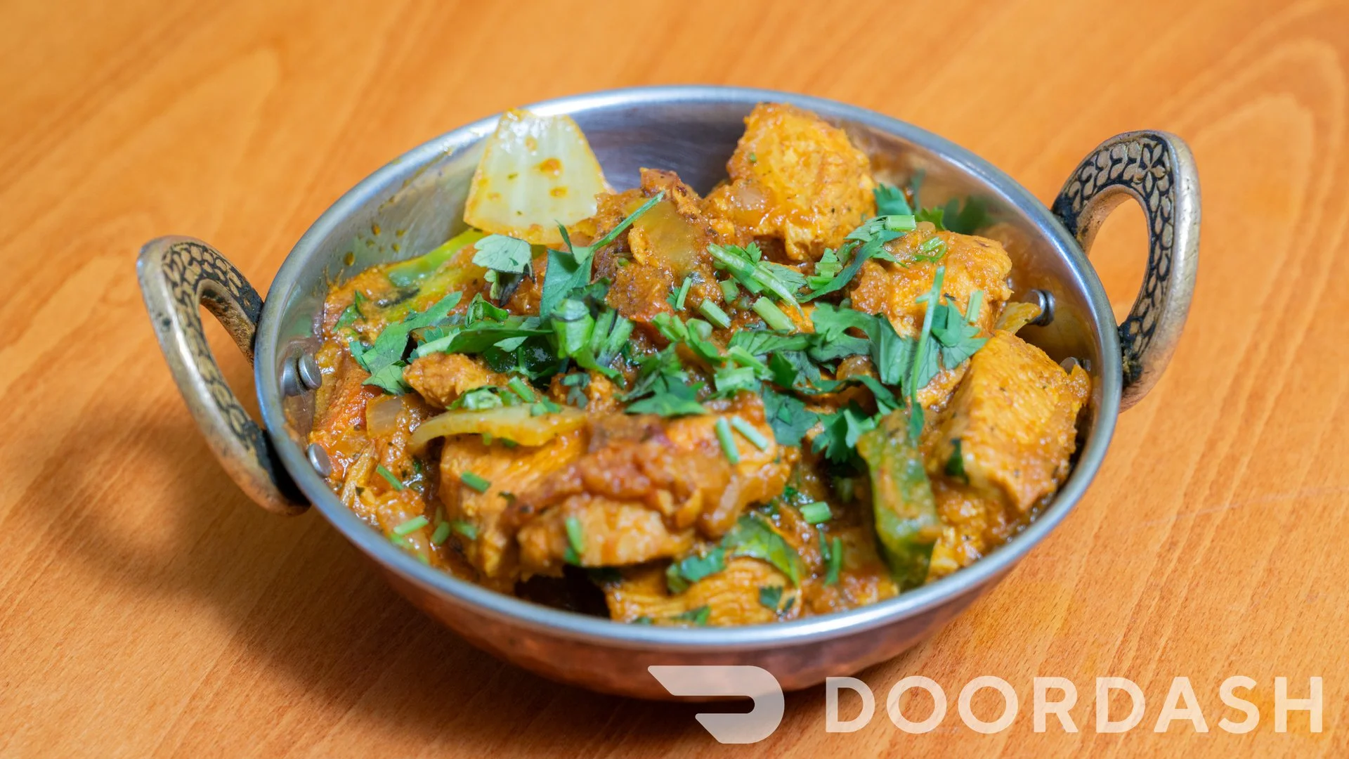 A colorful platter of Tandoori Chicken with fresh herbs