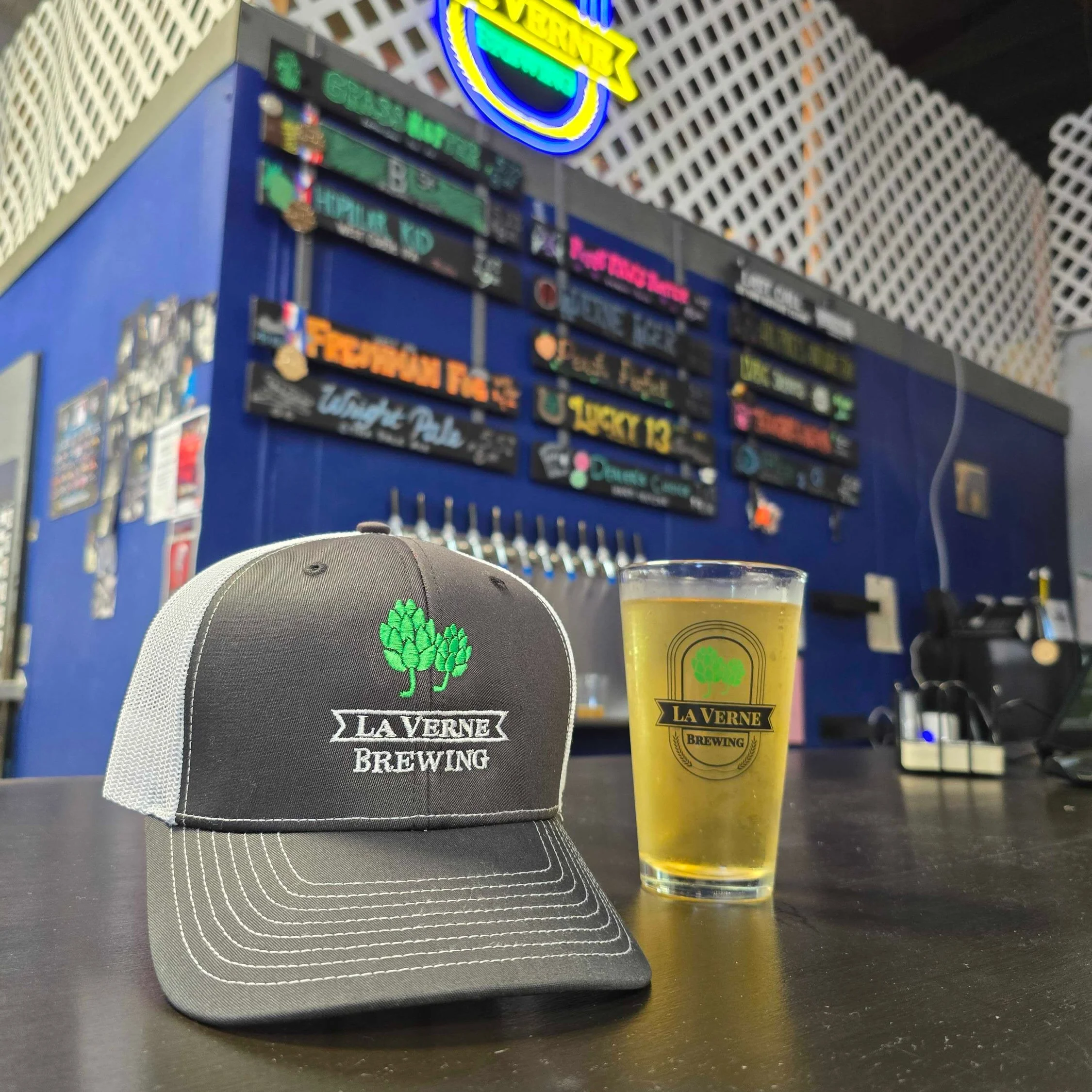 La Verne Brewing hat and beer on bar counter