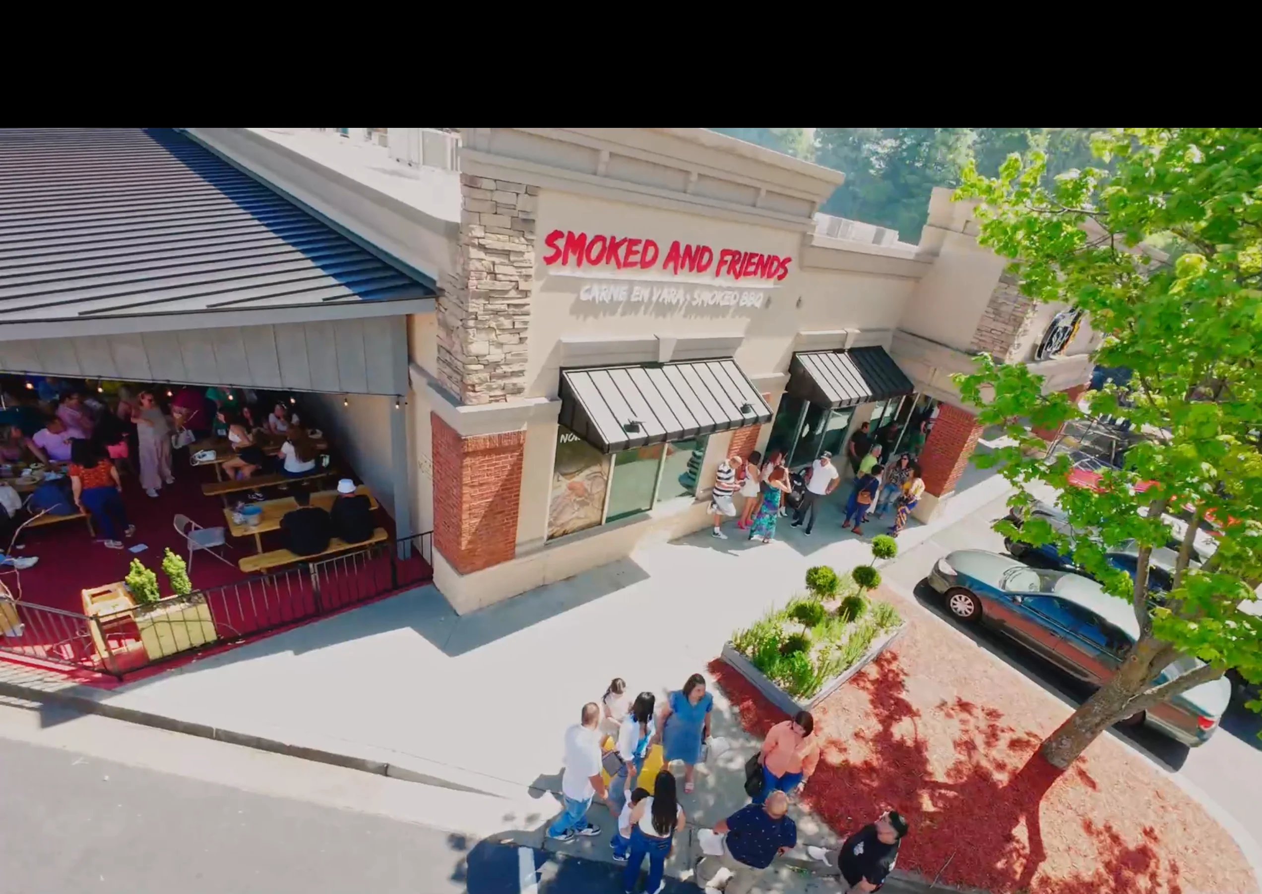 Busy restaurant exterior with outdoor seating and lively atmosphere