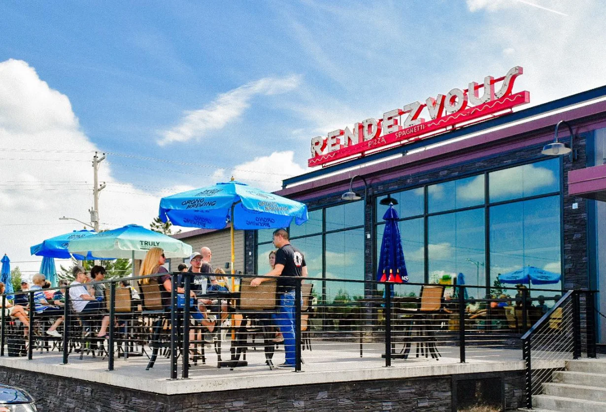 Outdoor dining area at a vibrant pizza restaurant