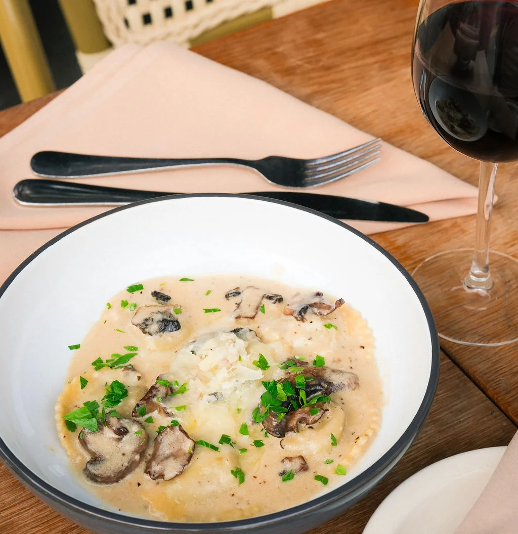 Creamy Italian mushroom ravioli with parsley garnish