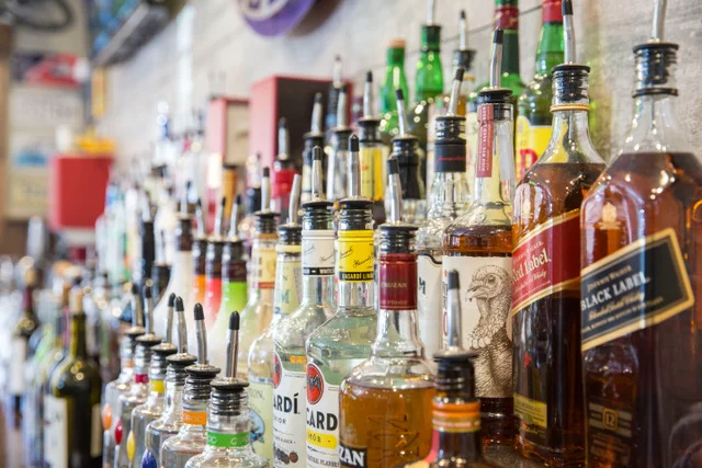 Variety of spirits and liquors on a bar shelf