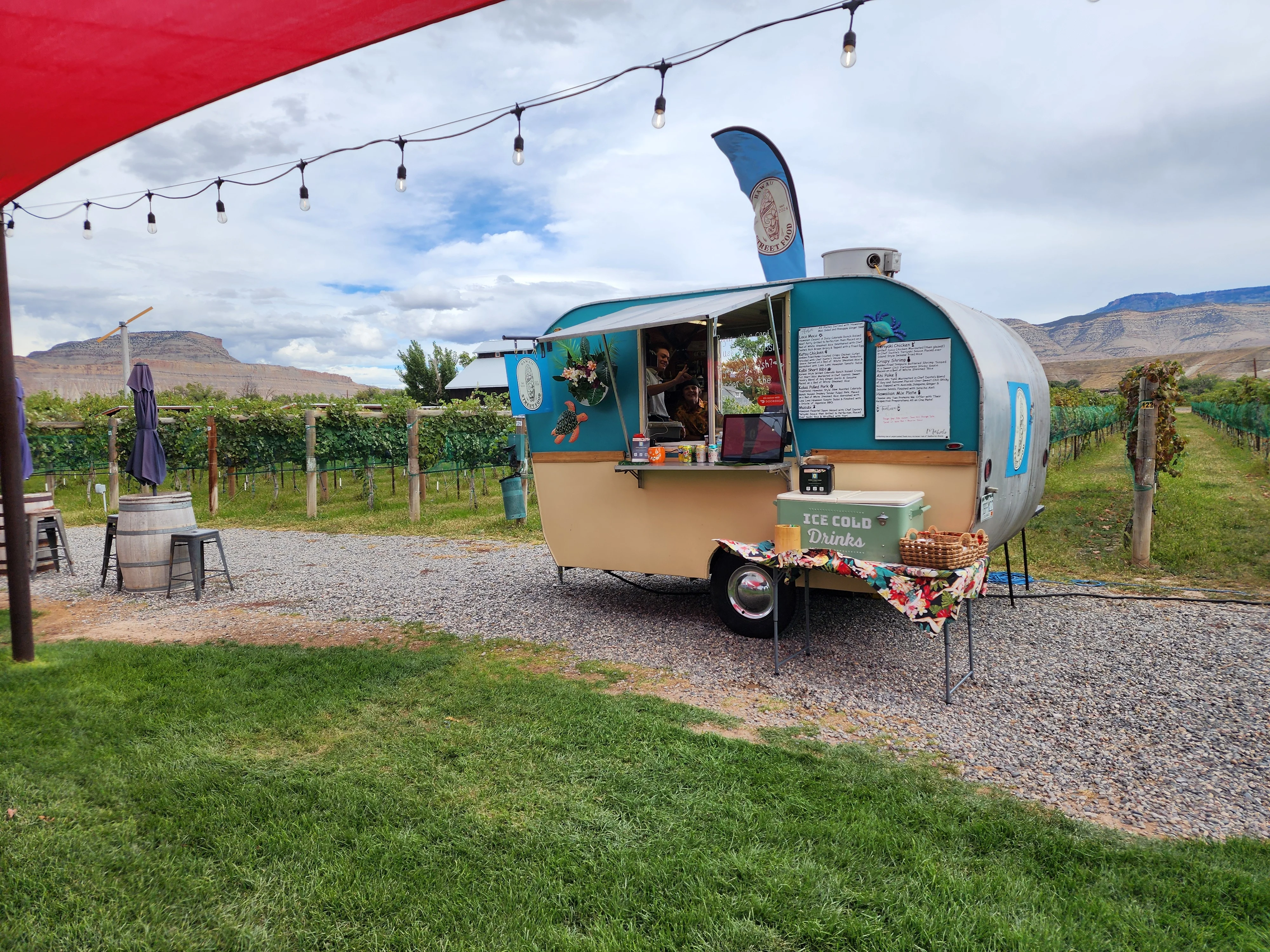 A scenic view of a winery with vineyards and a blue sky.