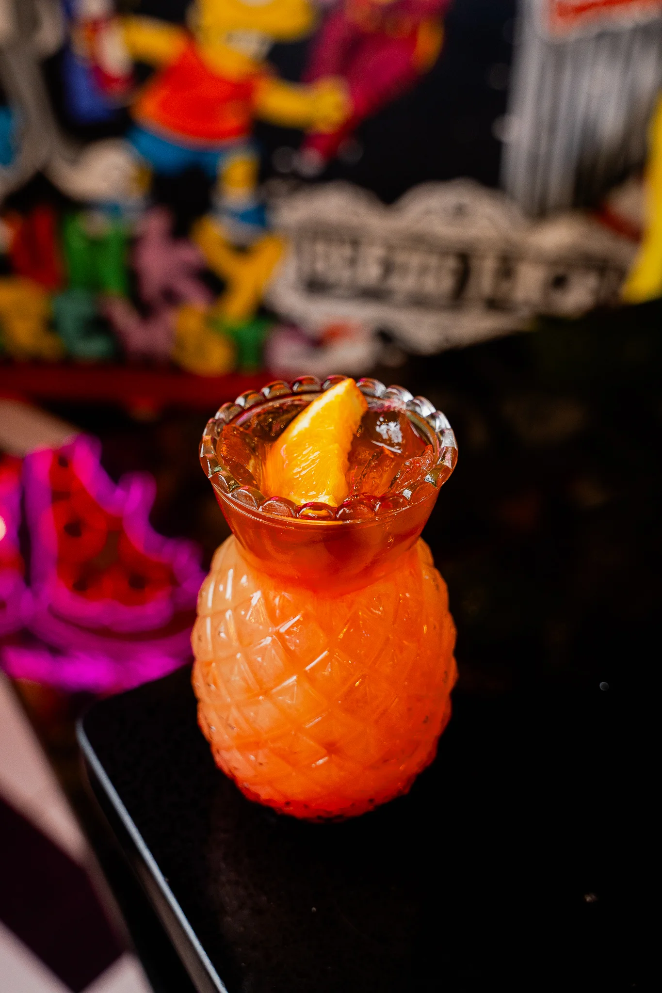 A vibrant display of colorful cocktails on a bar counter.