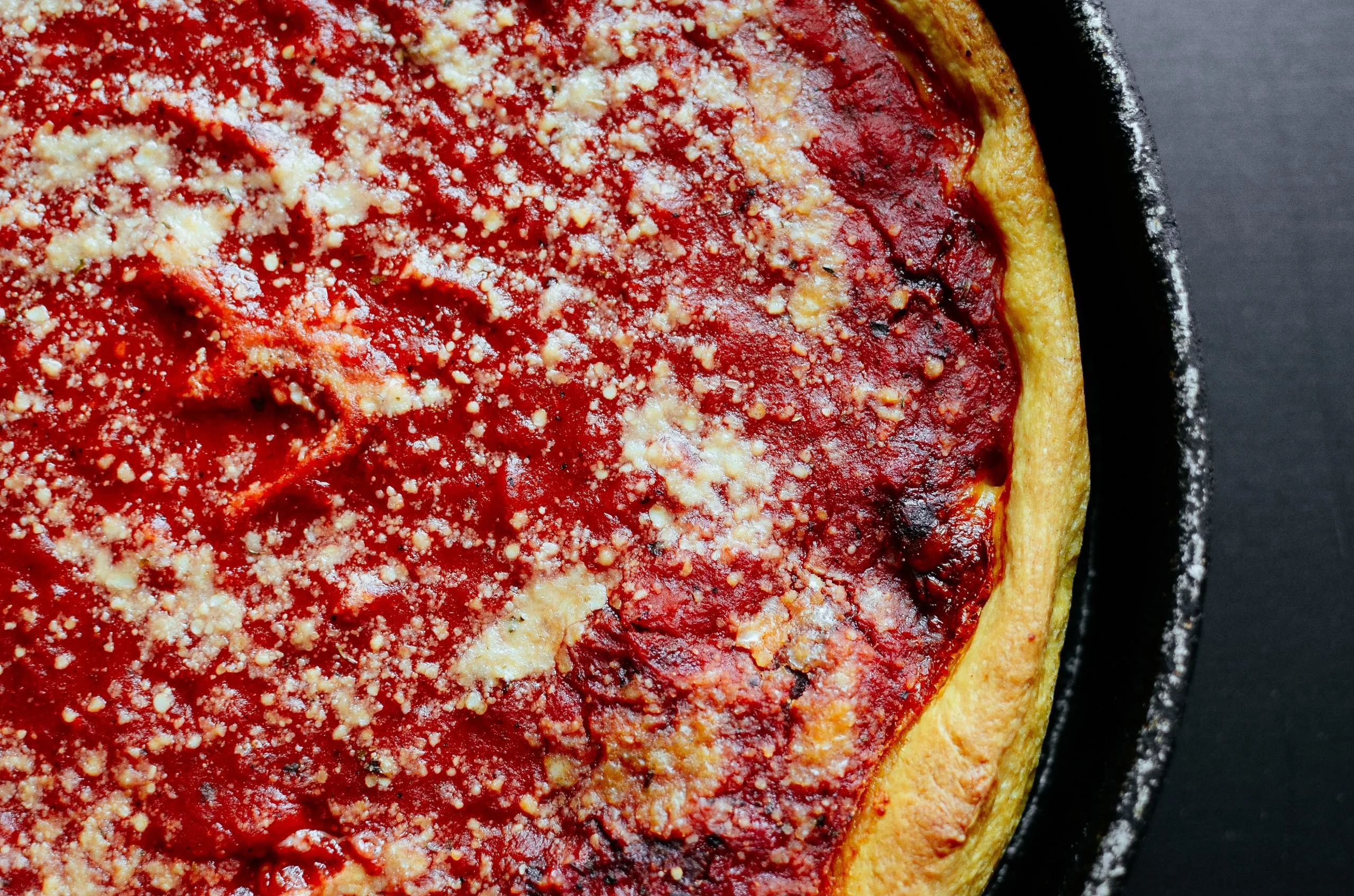 Deep-dish Chicago-style pizza with rich tomato sauce