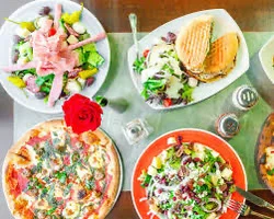 Italian pizza with fresh toppings and salads on a dining table
