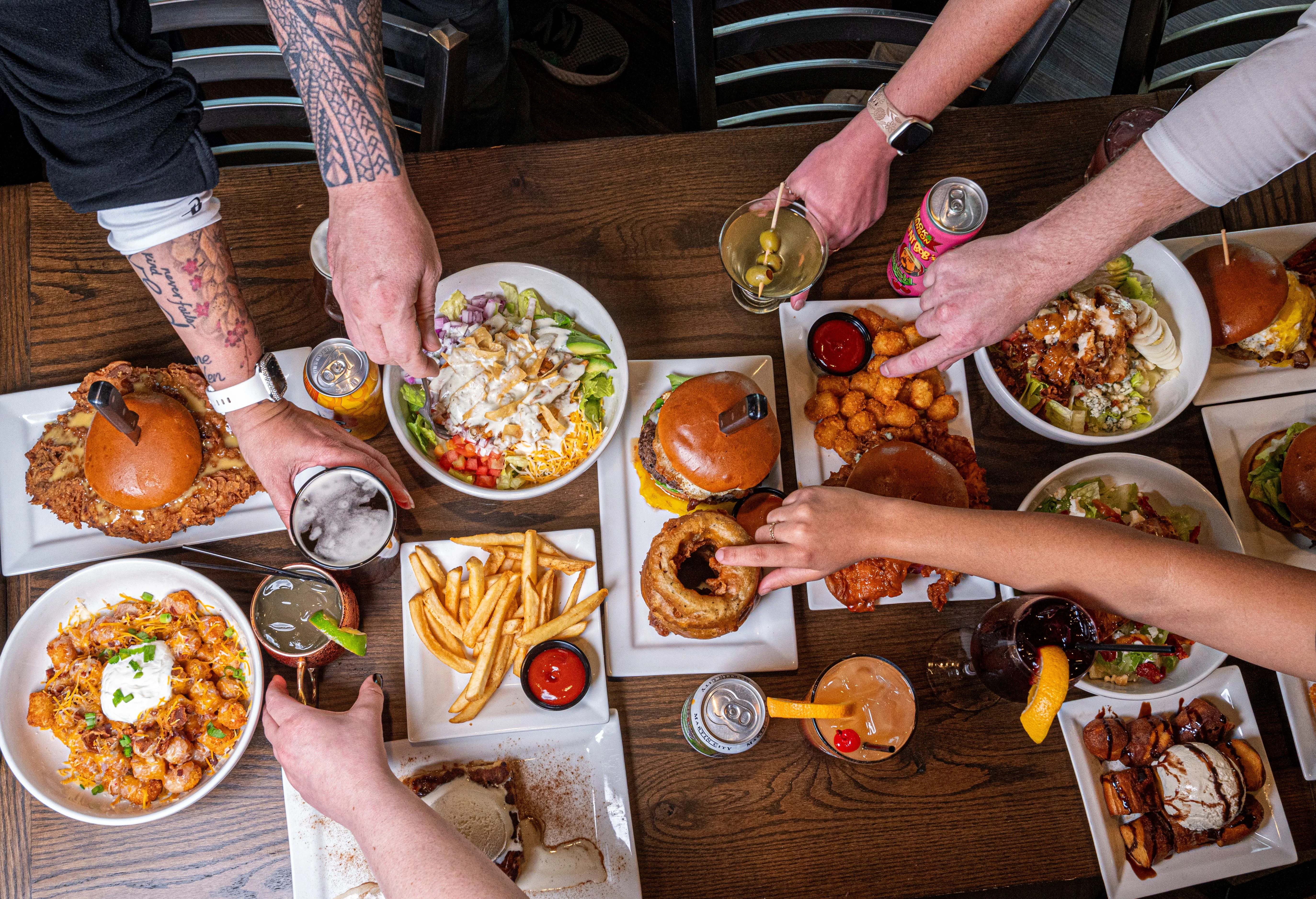 Variety of American comfort food dishes on a wooden table