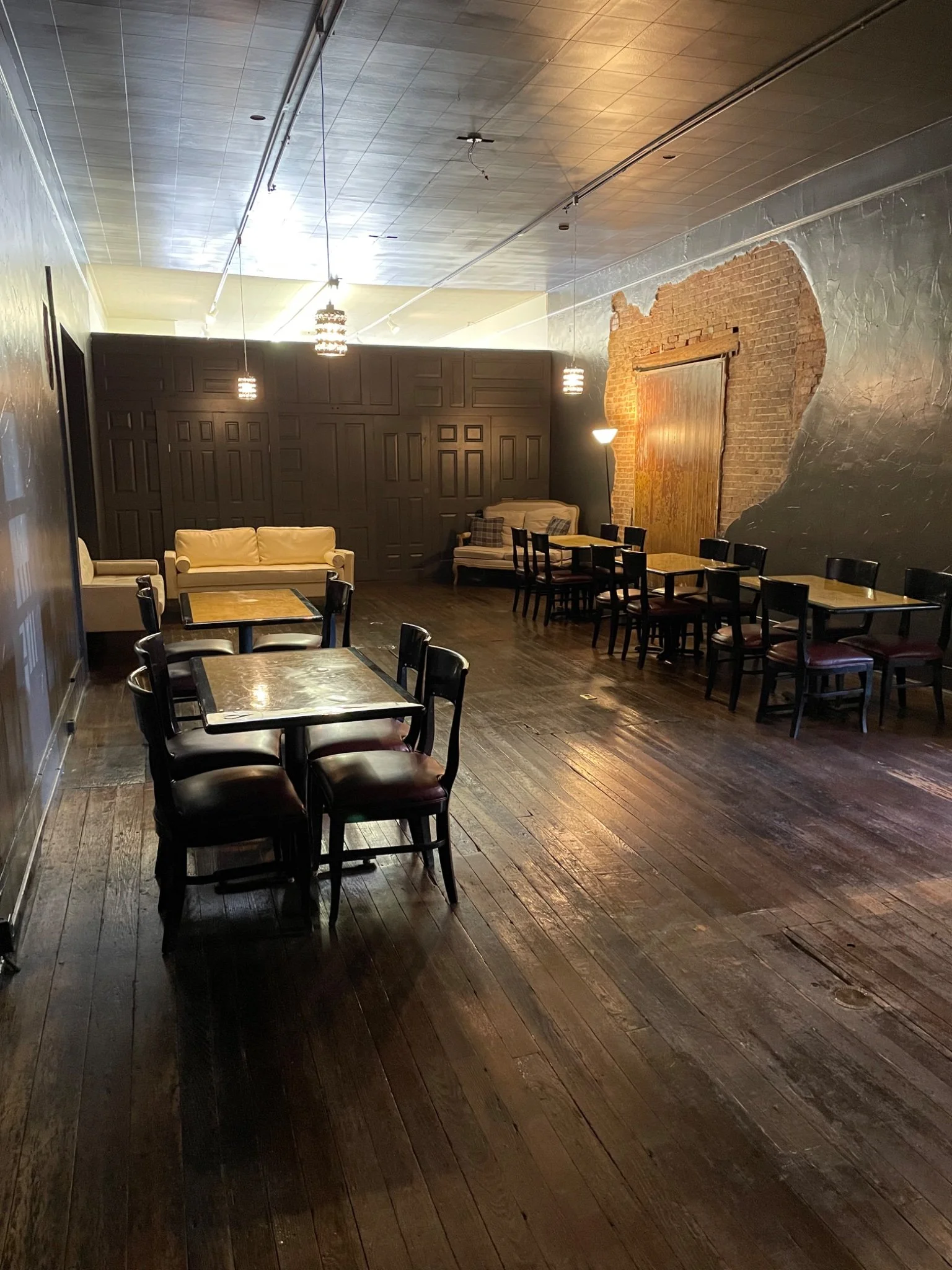 Cozy restaurant interior with wooden floors and warm lighting