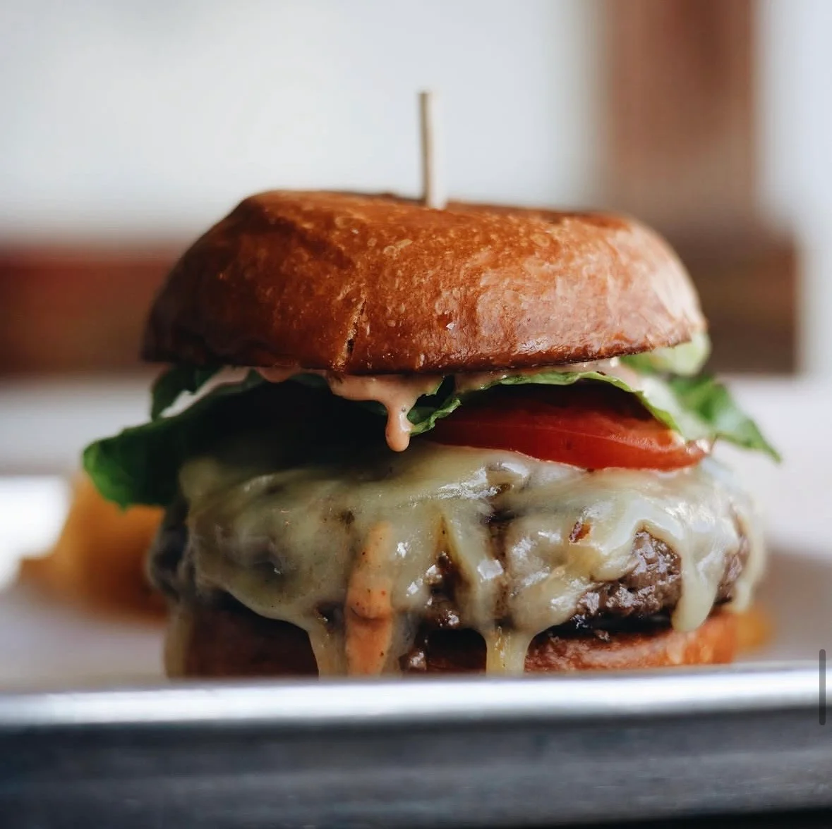 Juicy cheeseburger with lettuce and tomato on a toasted bun
