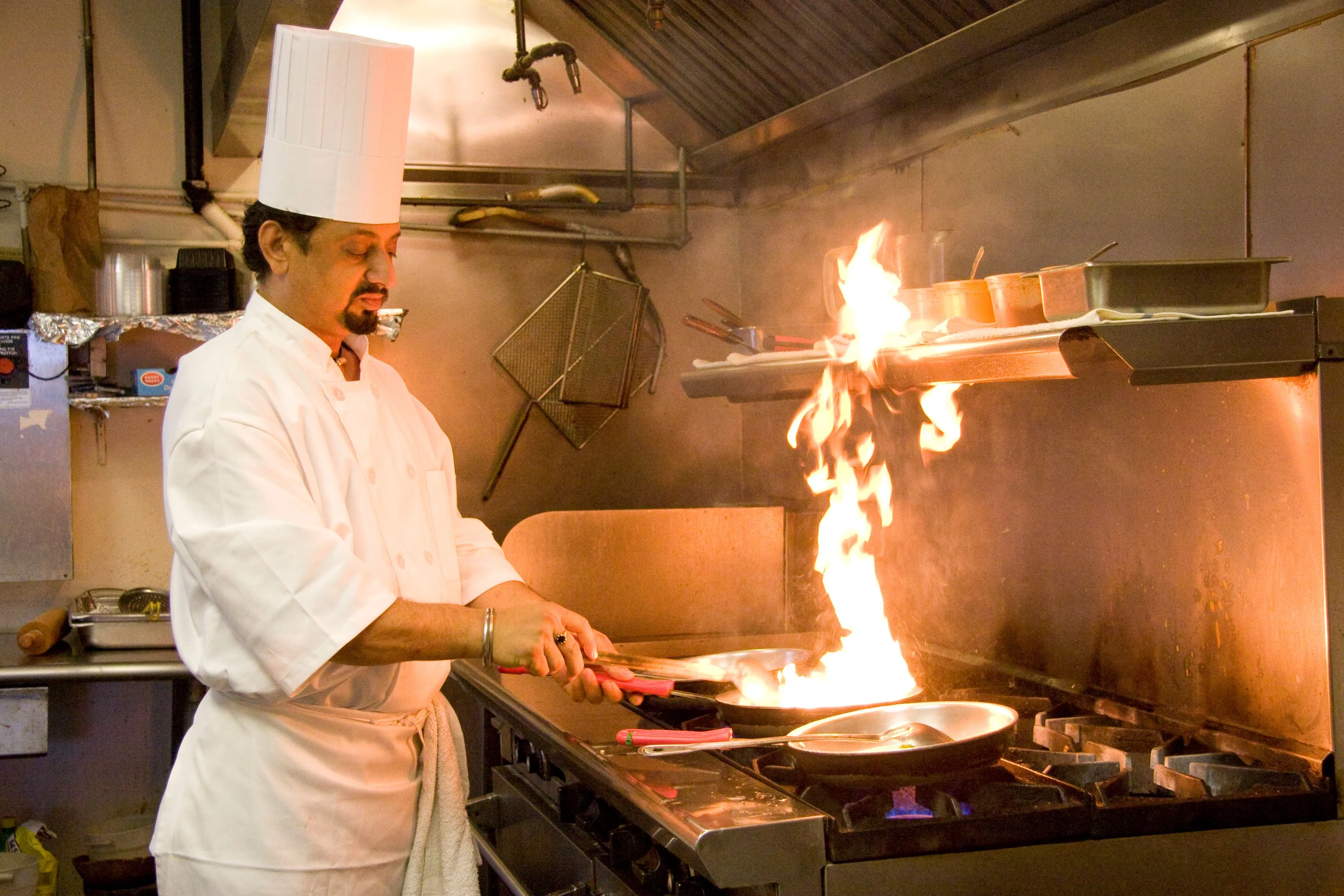 A restaurant chef preparing a dish