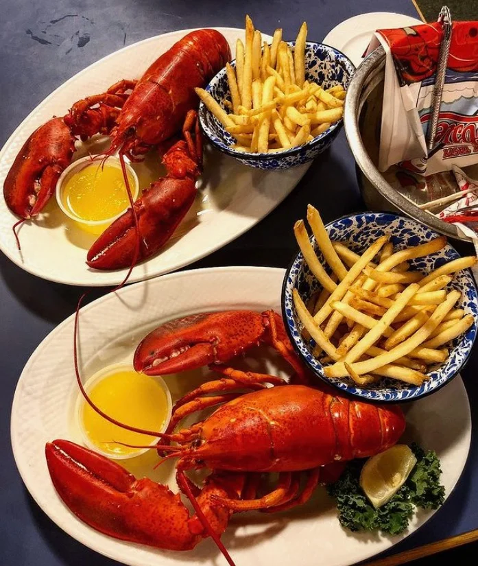 Classic New England lobster dinner with fries and butter