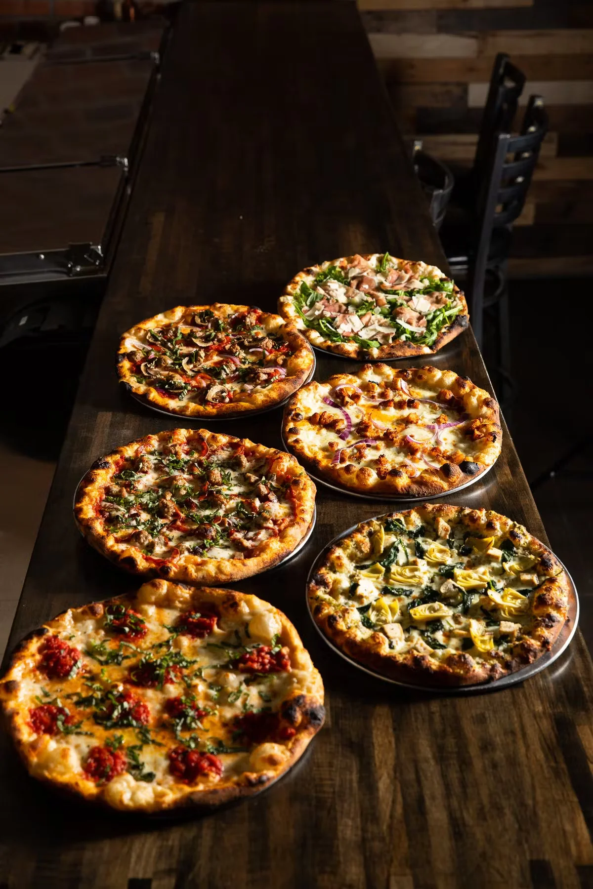 An array of freshly made pizzas