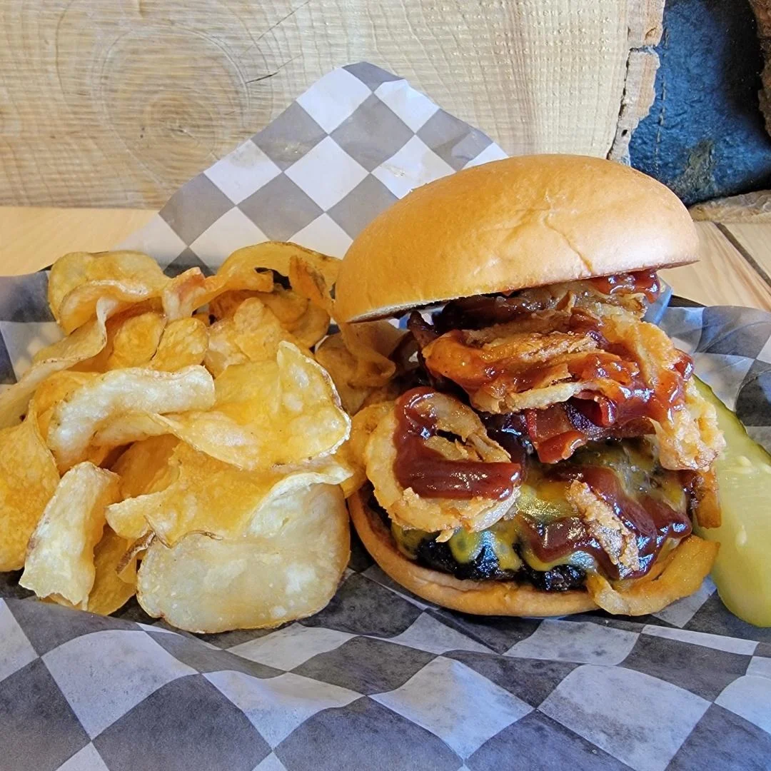 BBQ bacon cheeseburger with crispy onions and potato chips