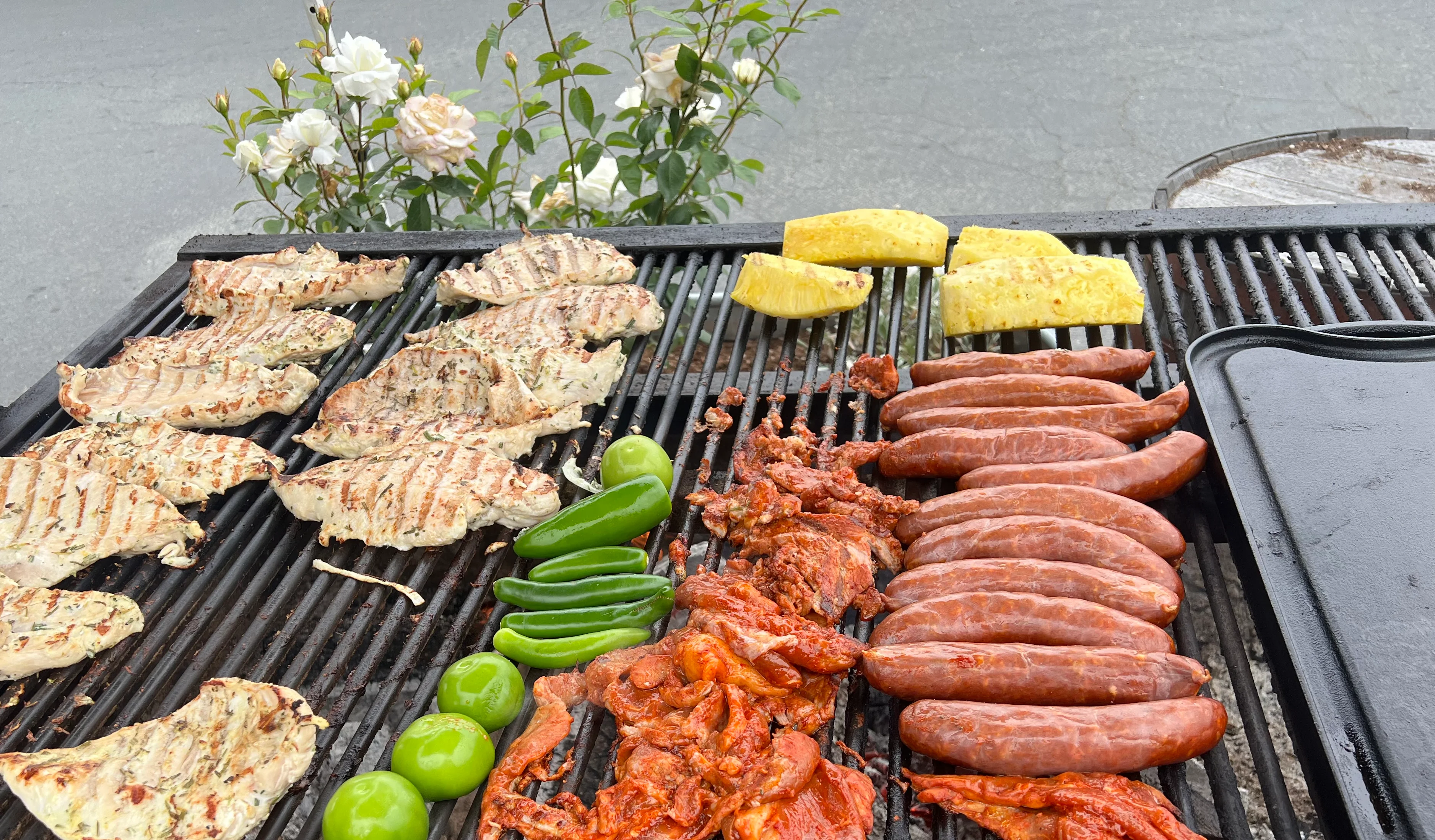 Grilled Mexican carne asada and chicken with jalapenos, tomatillos and pineapple