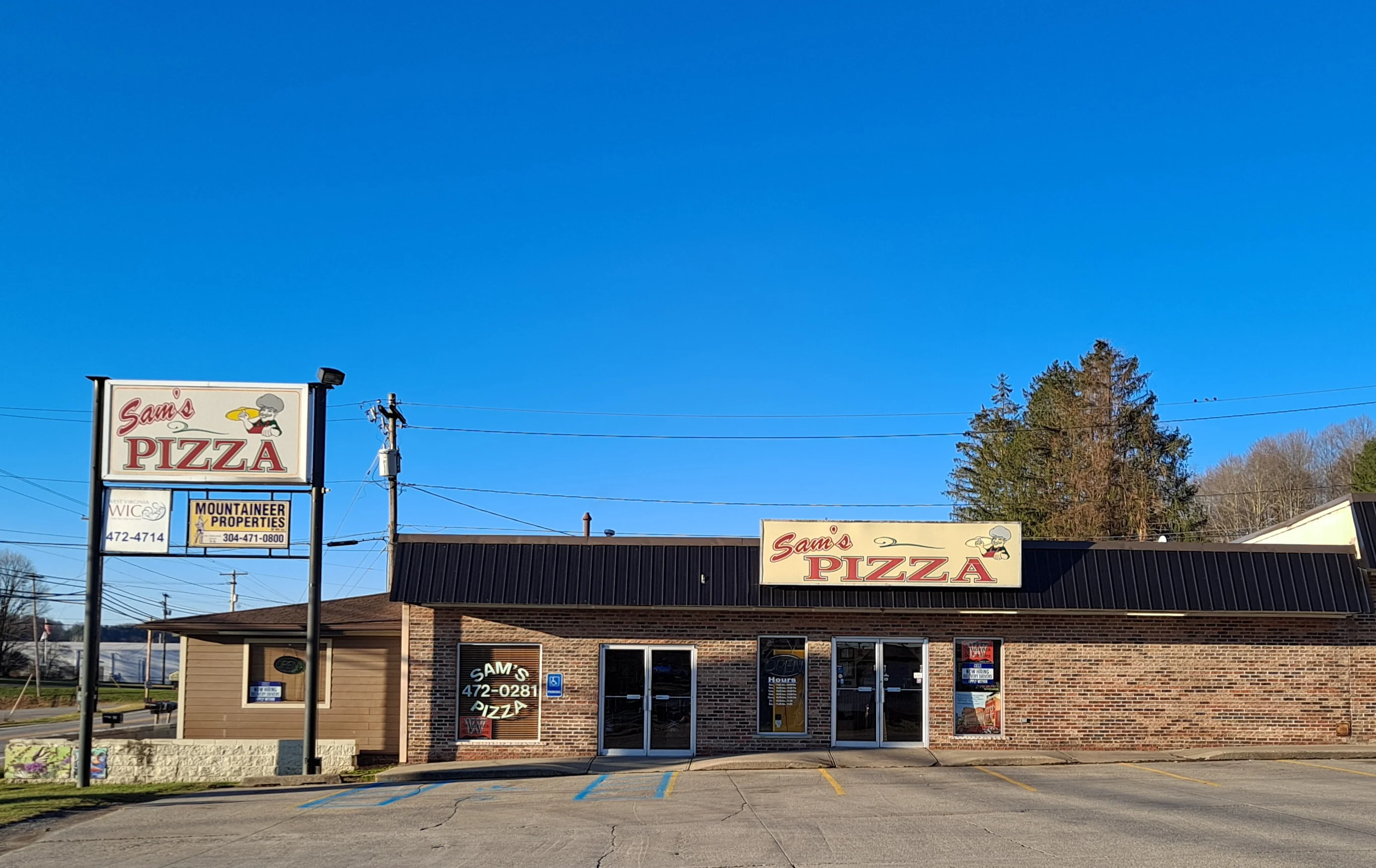 Exterior view of Sam's Pizza restaurant on a clear day