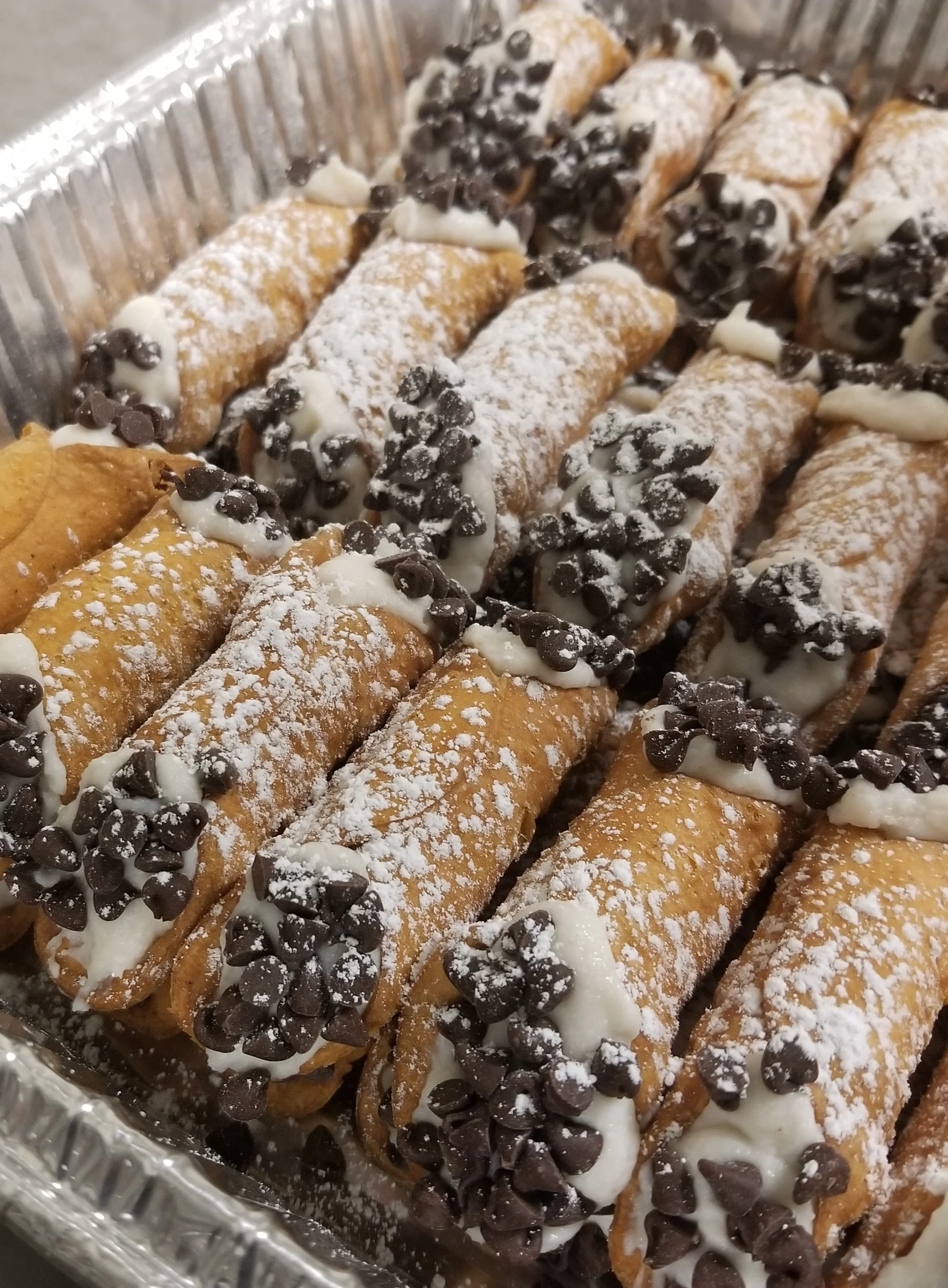 A tin foil dish full of desserts