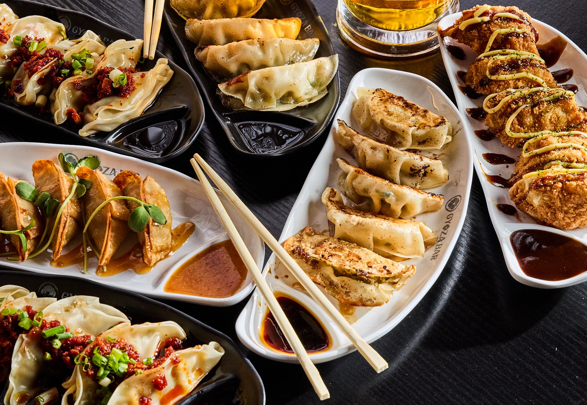 Assorted Japanese gyoza dumplings served with dipping sauces
