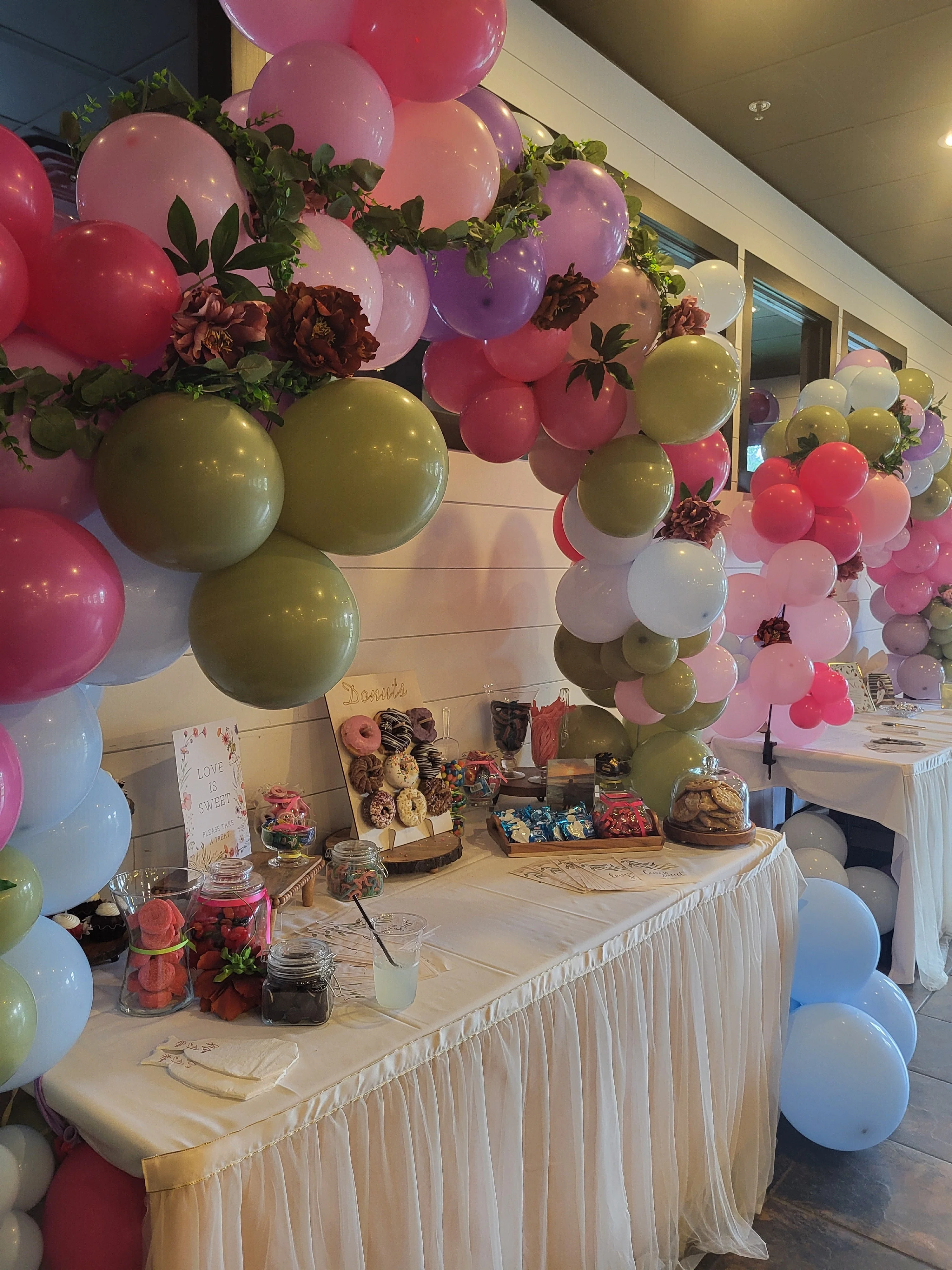 Colorful dessert table with balloons and sweets for a celebration