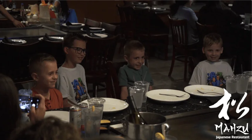 Kids smiling at a hibachi table during a birthday party at Mahzu East Windsor