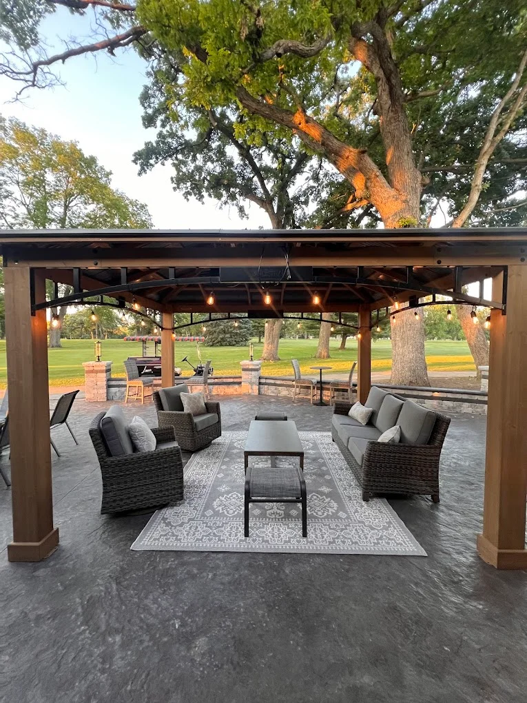 Outdoor seating area with cozy furniture and string lights