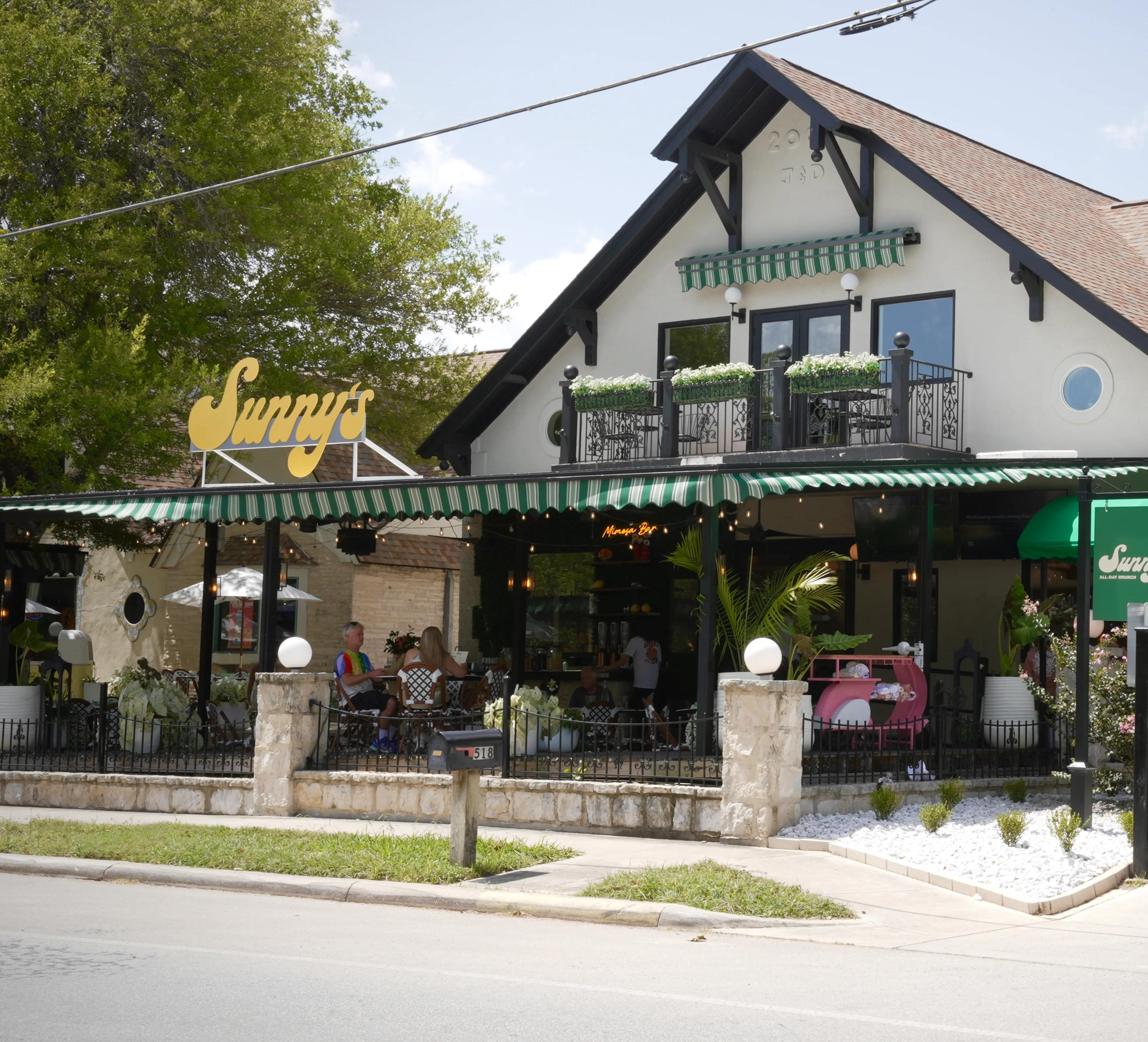Charming restaurant exterior with outdoor seating and vibrant signage