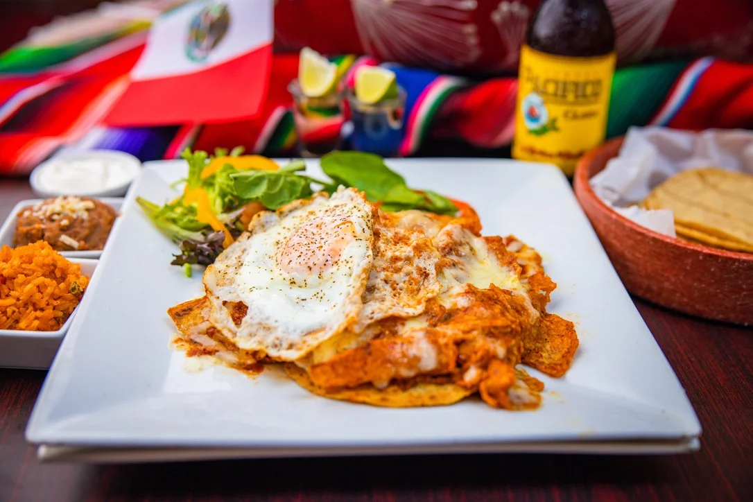 Delicious huevos rancheros served with rice and beans