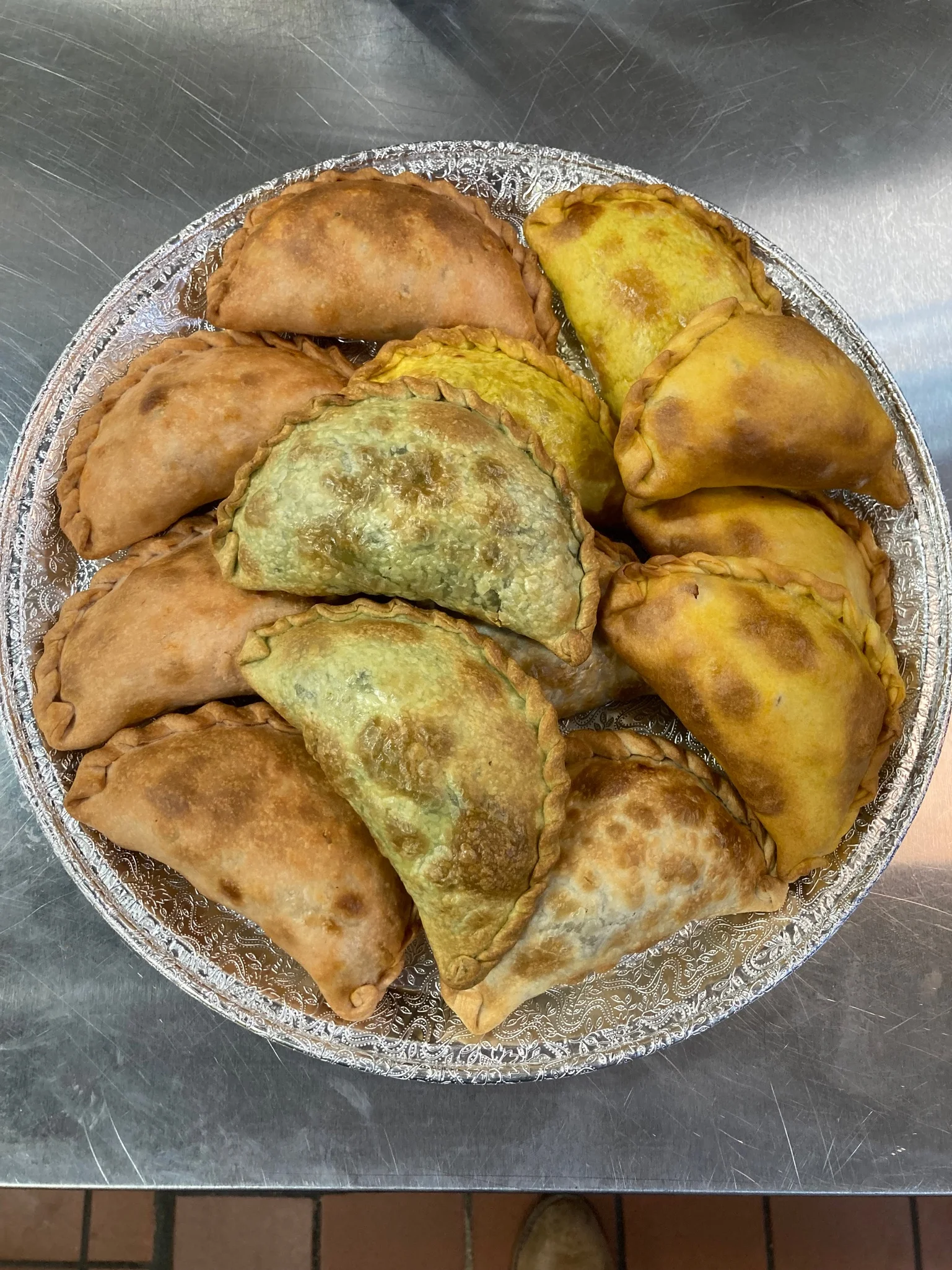 Assorted empanadas on a decorative platter
