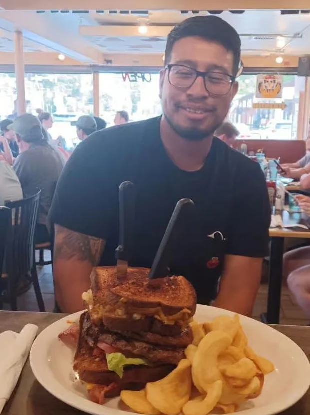 Giant American cheeseburger with fries in a lively restaurant