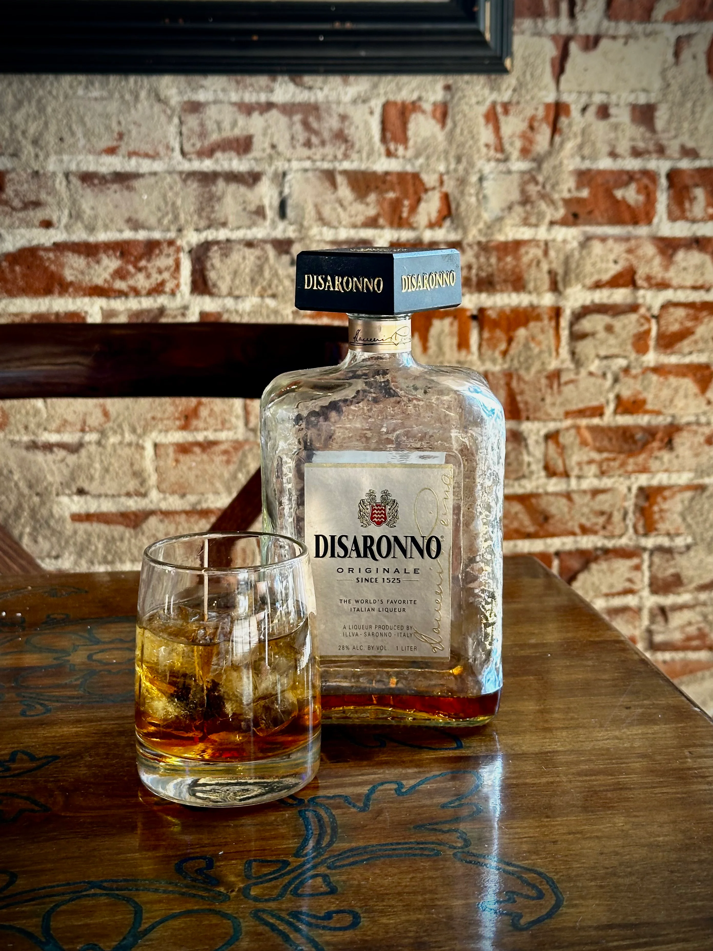 Disaronno liqueur served on the rocks in a cozy bar setting
